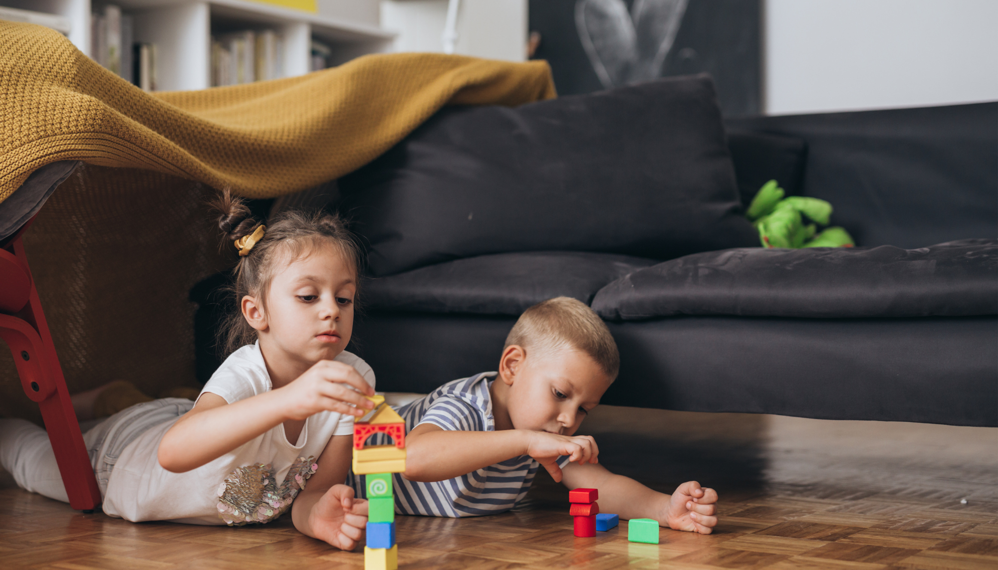 Children playing with building blocks during developmental play representing ADHD, autism, and neurodivergent support services at Sharp Wellness.
