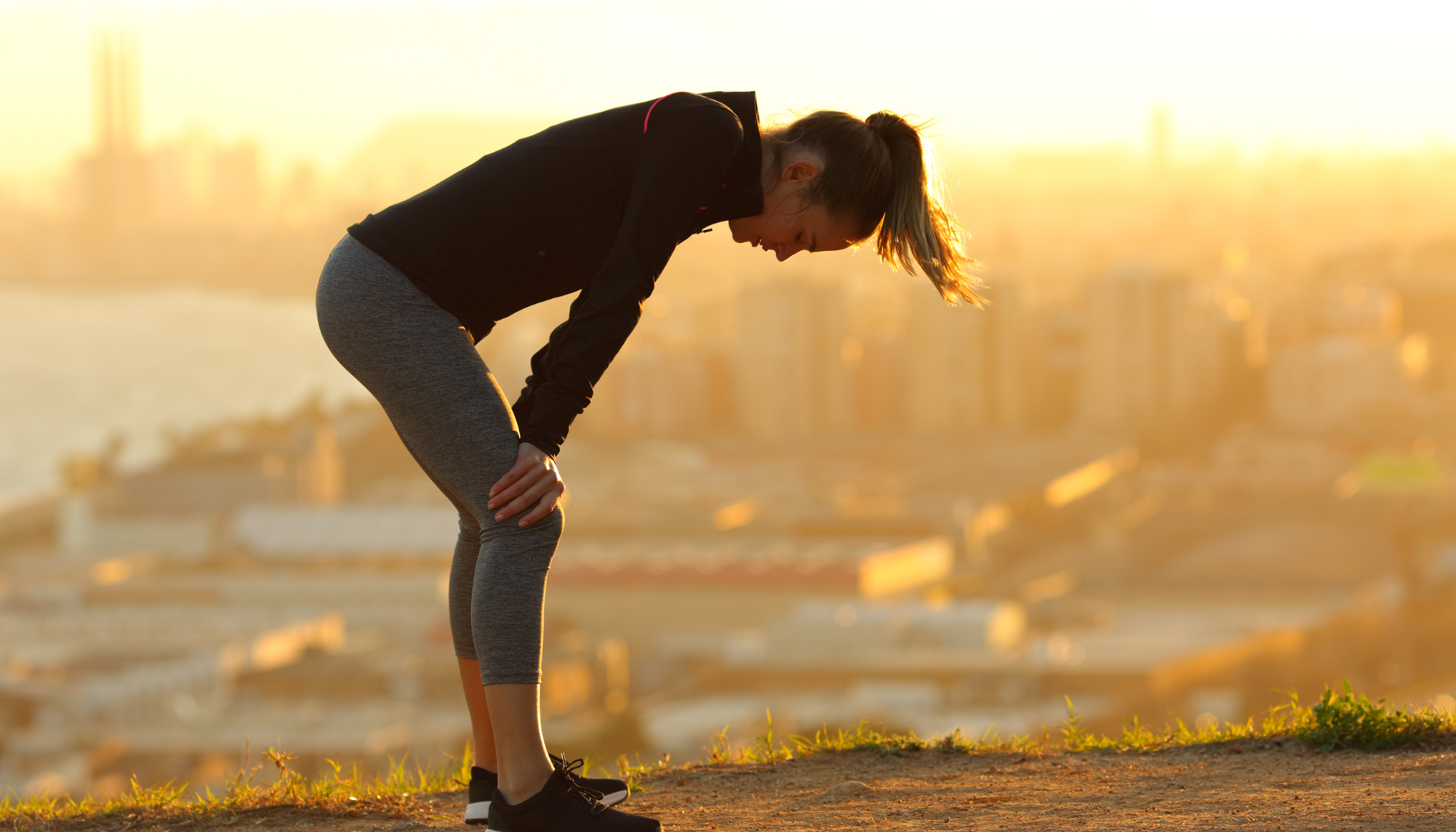 Woman experiencing fatigue and emotional exhaustion during outdoor exercise, illustrating burnout, emotional suppression, chronic stress, anxiety, and mental wellness in Birmingham, Alabama.