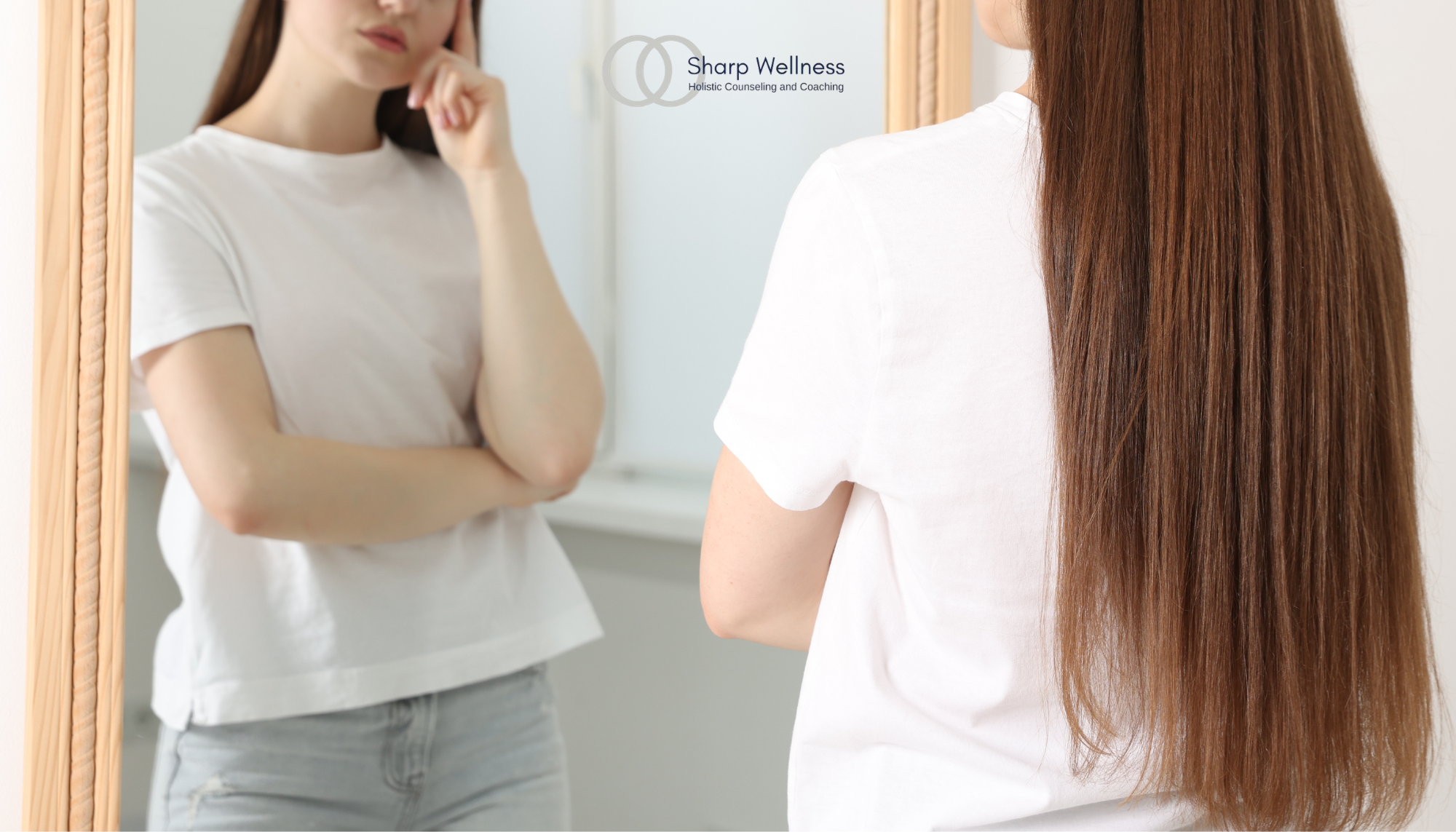 Woman looking thoughtfully at her reflection in a mirror, illustrating self-criticism, perfectionism, and a harsh inner critic.