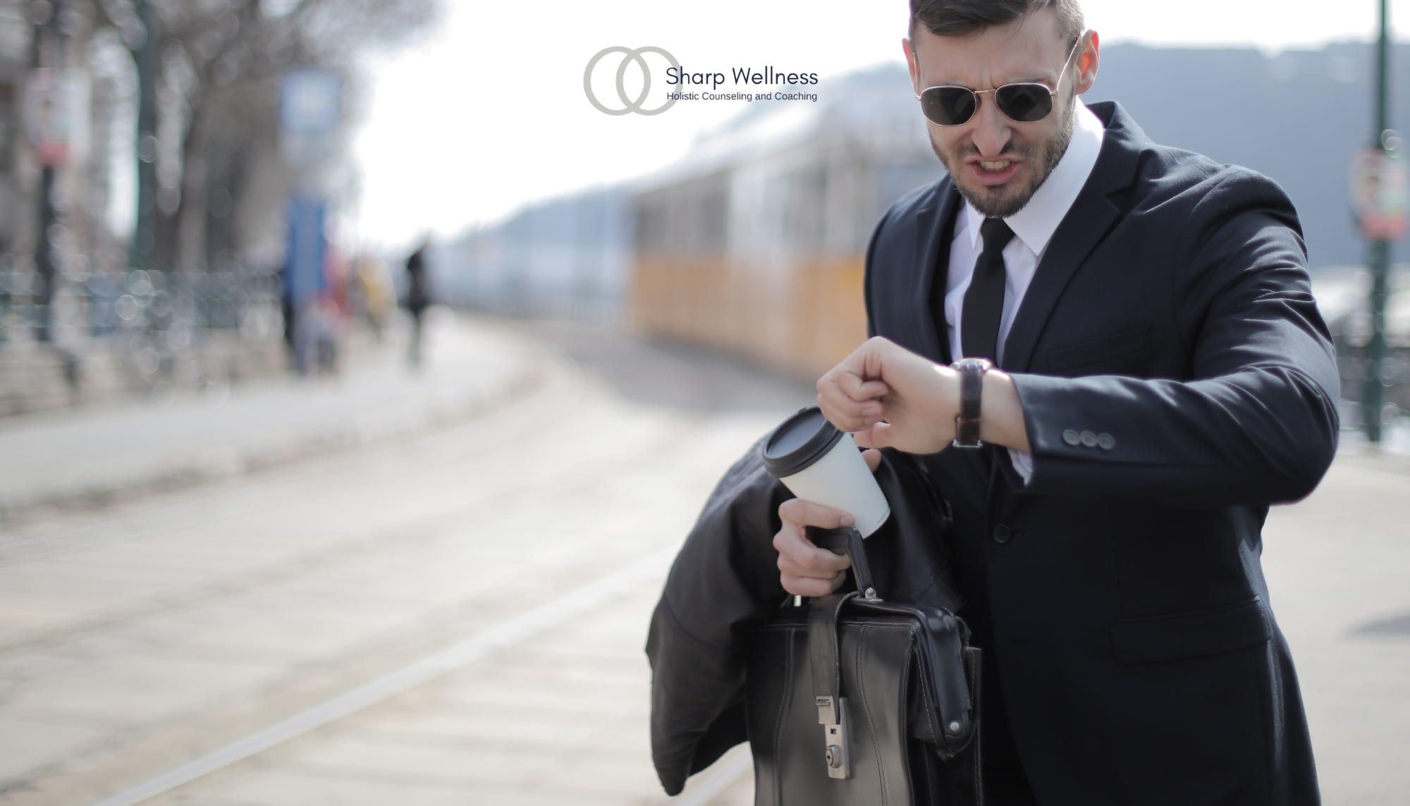 Business professional checking his watch while holding coffee and a briefcase, representing time management, lateness, and adult ADHD.