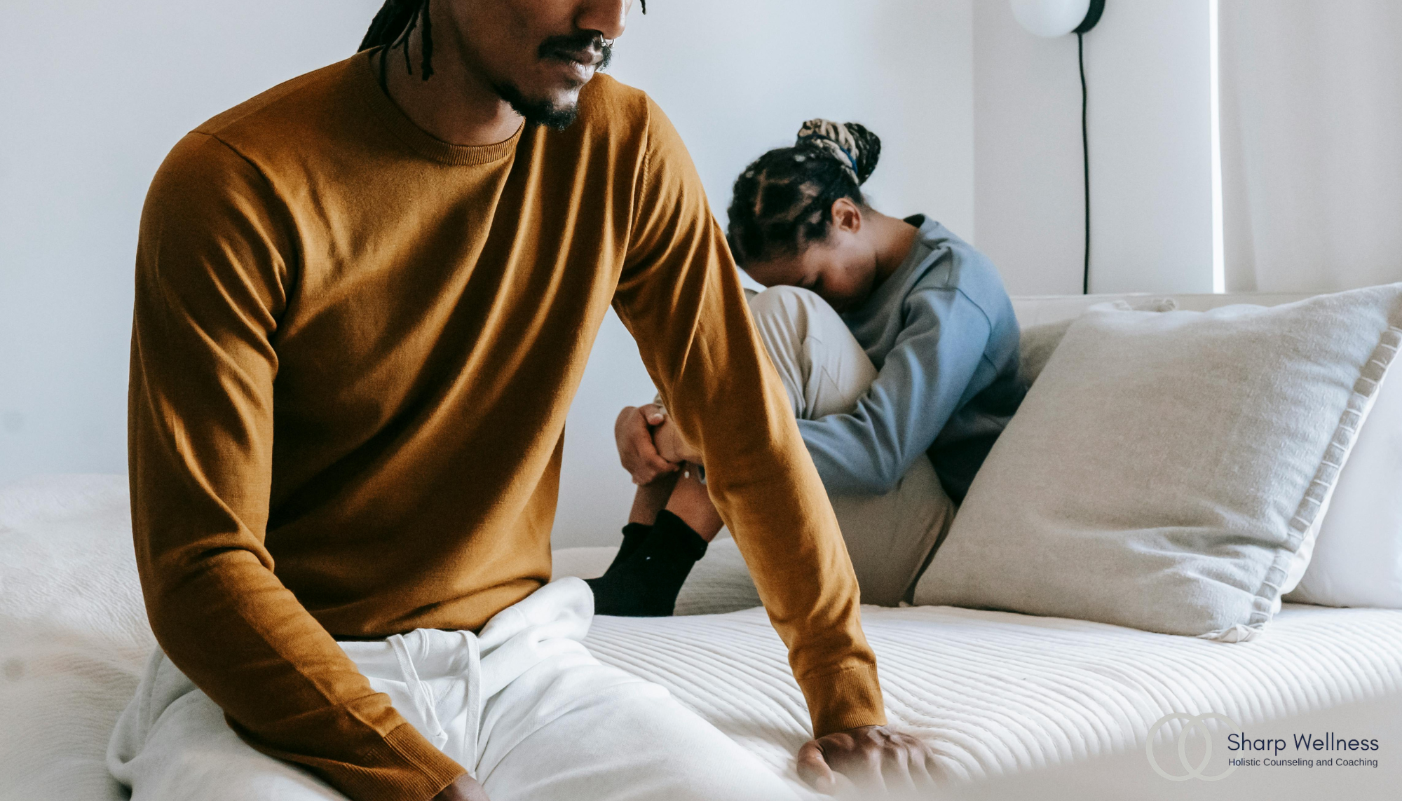 Couple sitting apart after an emotional conflict, illustrating emotional avoidance, disconnection, and relationship stress.