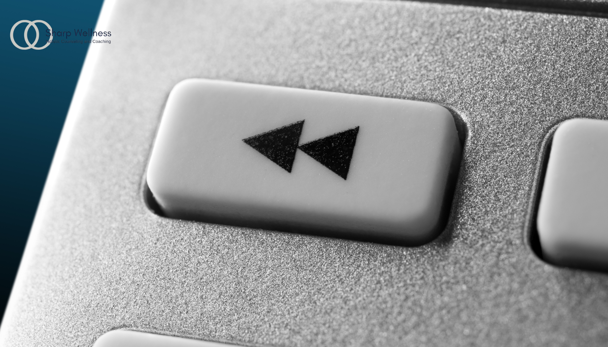 Close-up of a rewind button symbol representing replaying past events, memories, or thoughts.