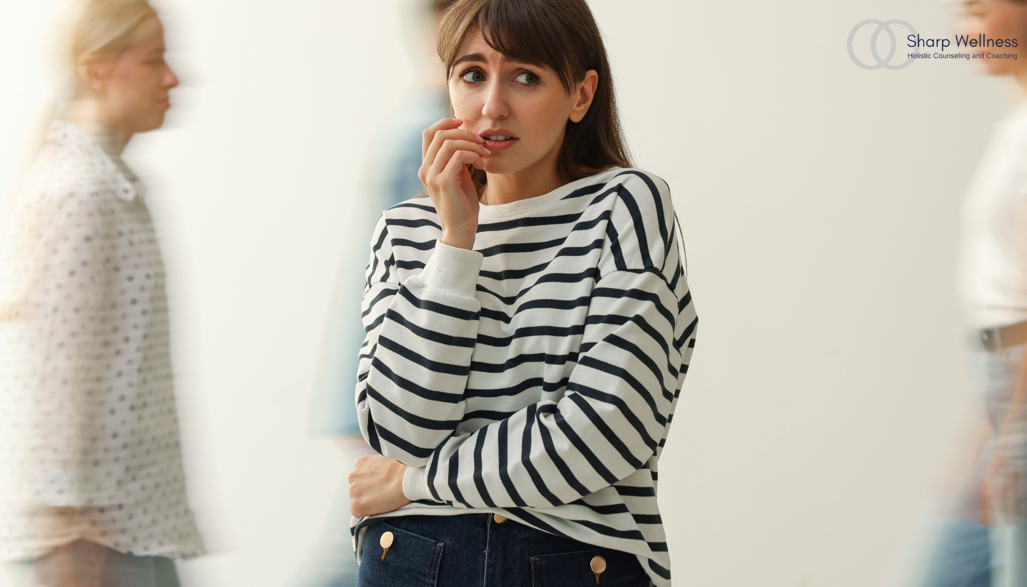 Person appearing anxious and hesitant in a social setting, representing people-pleasing patterns, boundary setting, anxiety therapy, and mental health counseling in McKinney, TX.