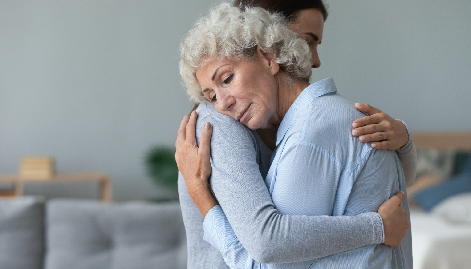 Older woman receiving comfort and support while coping with grief, loss, and difficult life changes.