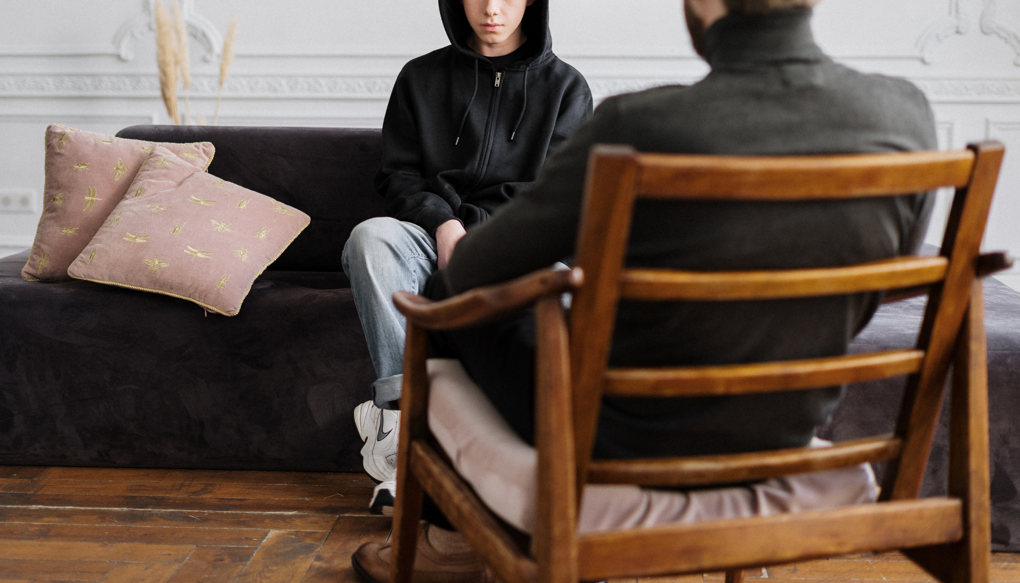 Teen therapy session in Birmingham, AL with a counselor providing support for emotional challenges, anxiety, stress, and mental health concerns in a comfortable counseling office near Vestavia Hills.
