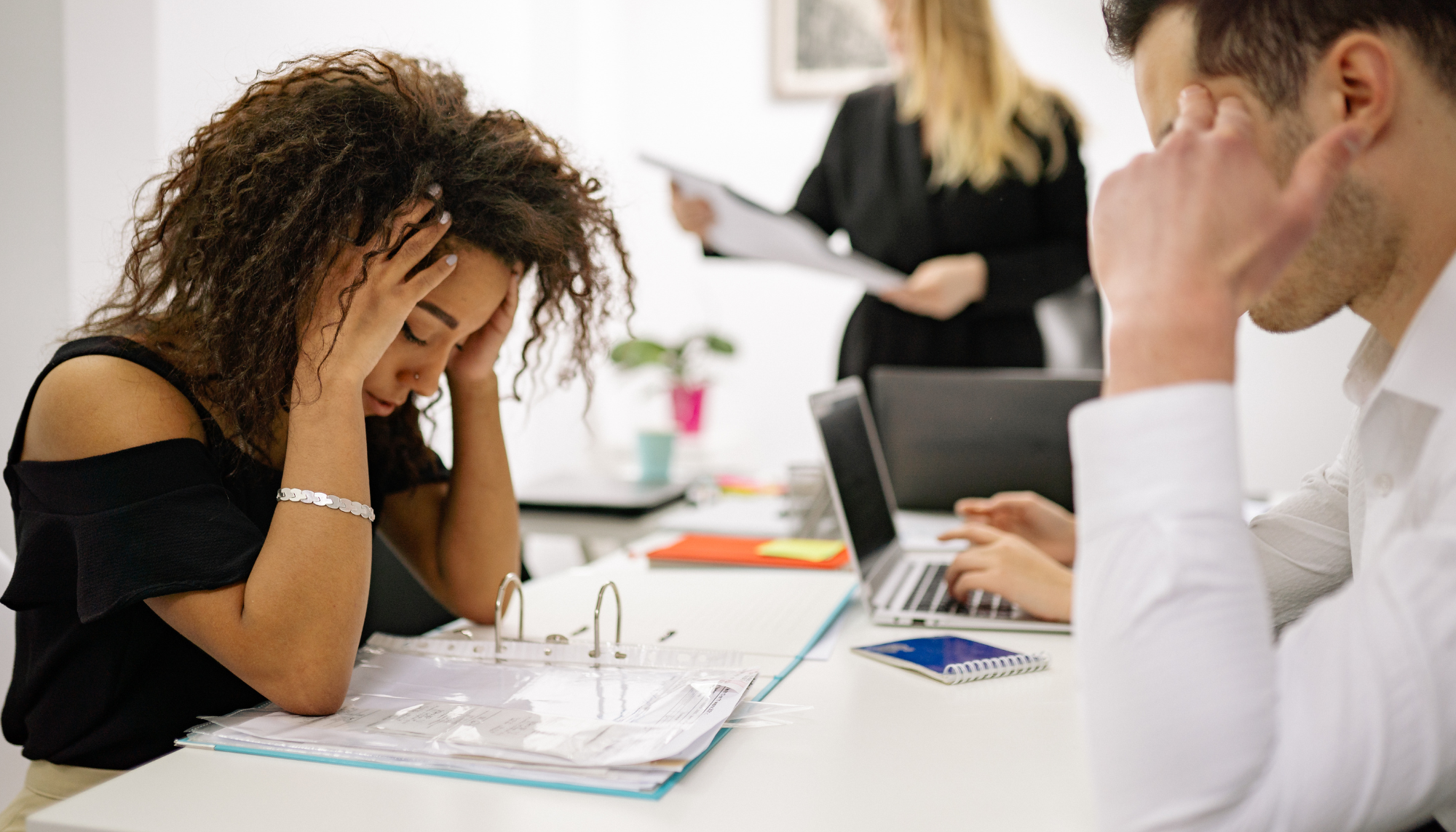 Overwhelmed employees at work, representing job stress, burnout, mental exhaustion, and therapy for managing chronic stress and overwhelm.