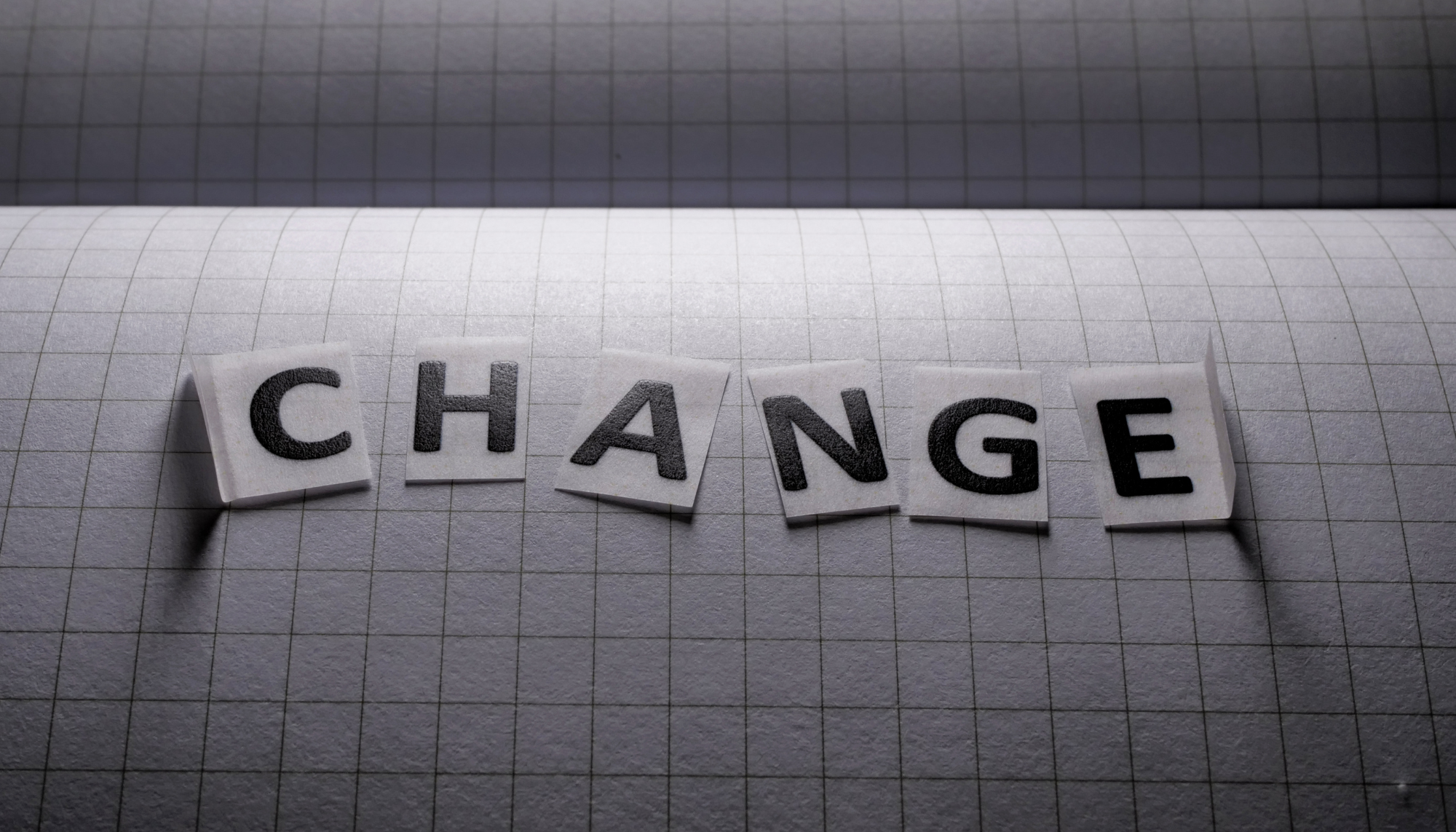 Letter tiles spelling "CHANGE" on a notebook background, representing life transitions, personal growth, coping with change, stress management, and therapy support in Birmingham, Alabama.