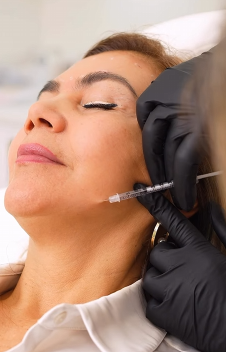 Woman receiving a facial injection in a medical setting