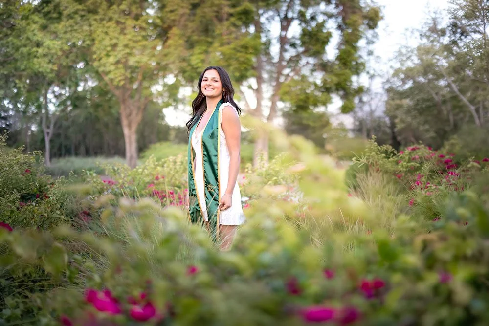Soft afternoon light filtering through the garden creates a warm, natural portrait on campus.