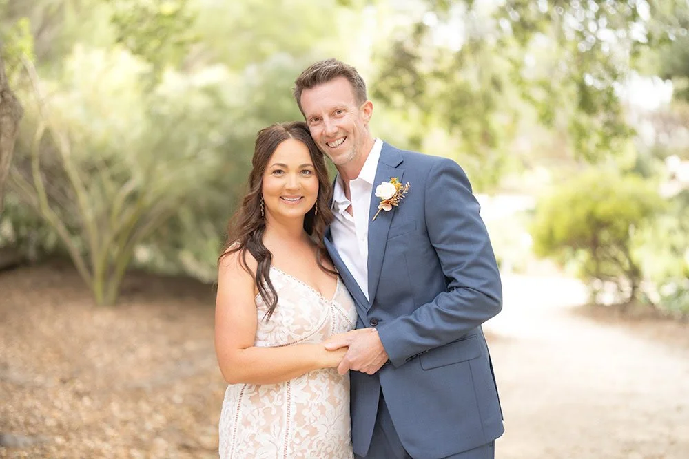 Newlywed bride and groom embracing beneath an oak tree at the San Luis Obispo Botanical Garden