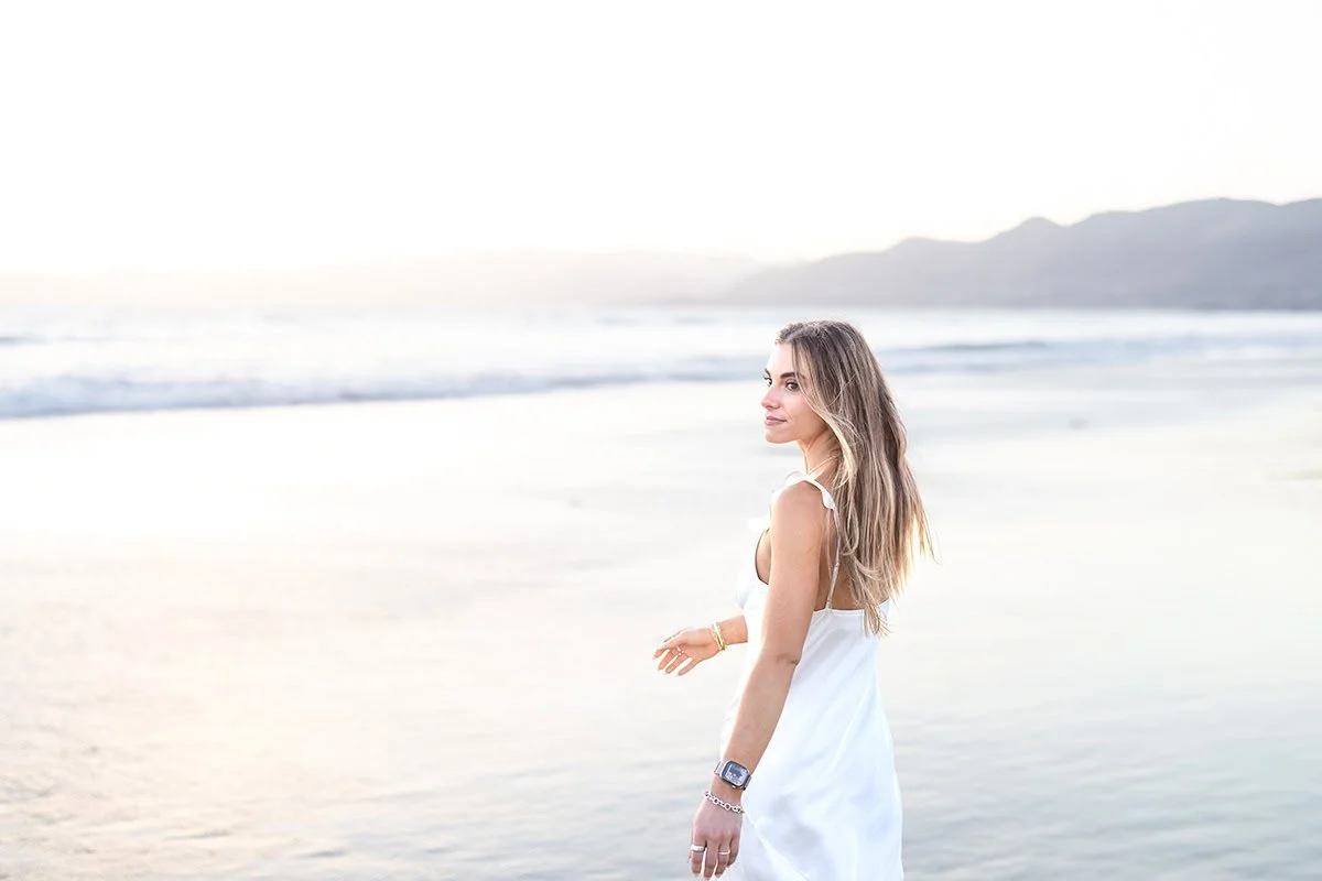 Cal Poly senior looking back over her shoulder on the beach