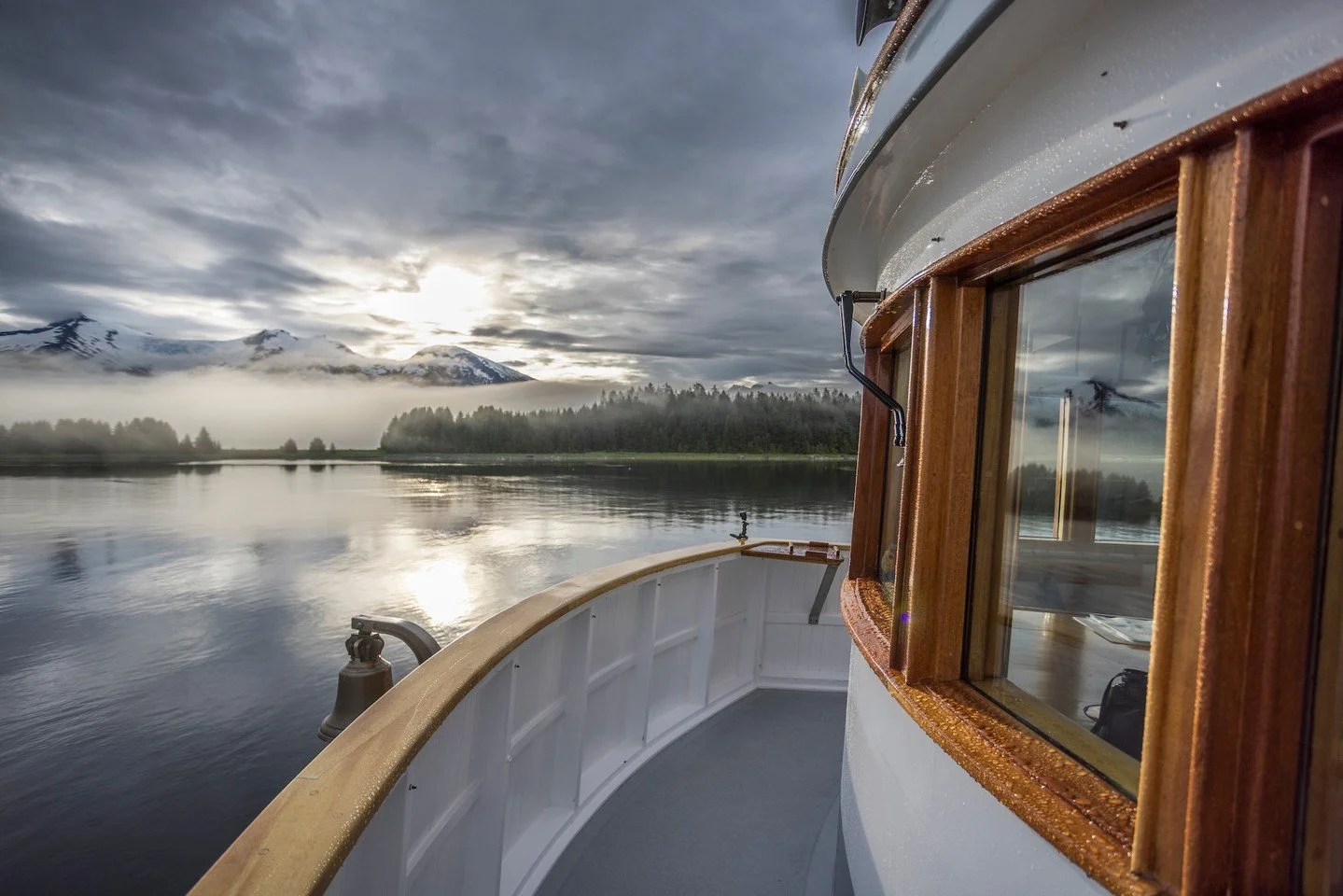 Some moments on the water are loud &mdash; whales surfacing, glaciers calving, eagles calling.
And then there are moments like this.

Early morning, the boat barely moving, the bell quiet, the forest wrapped in fog and the mountains holding the first
