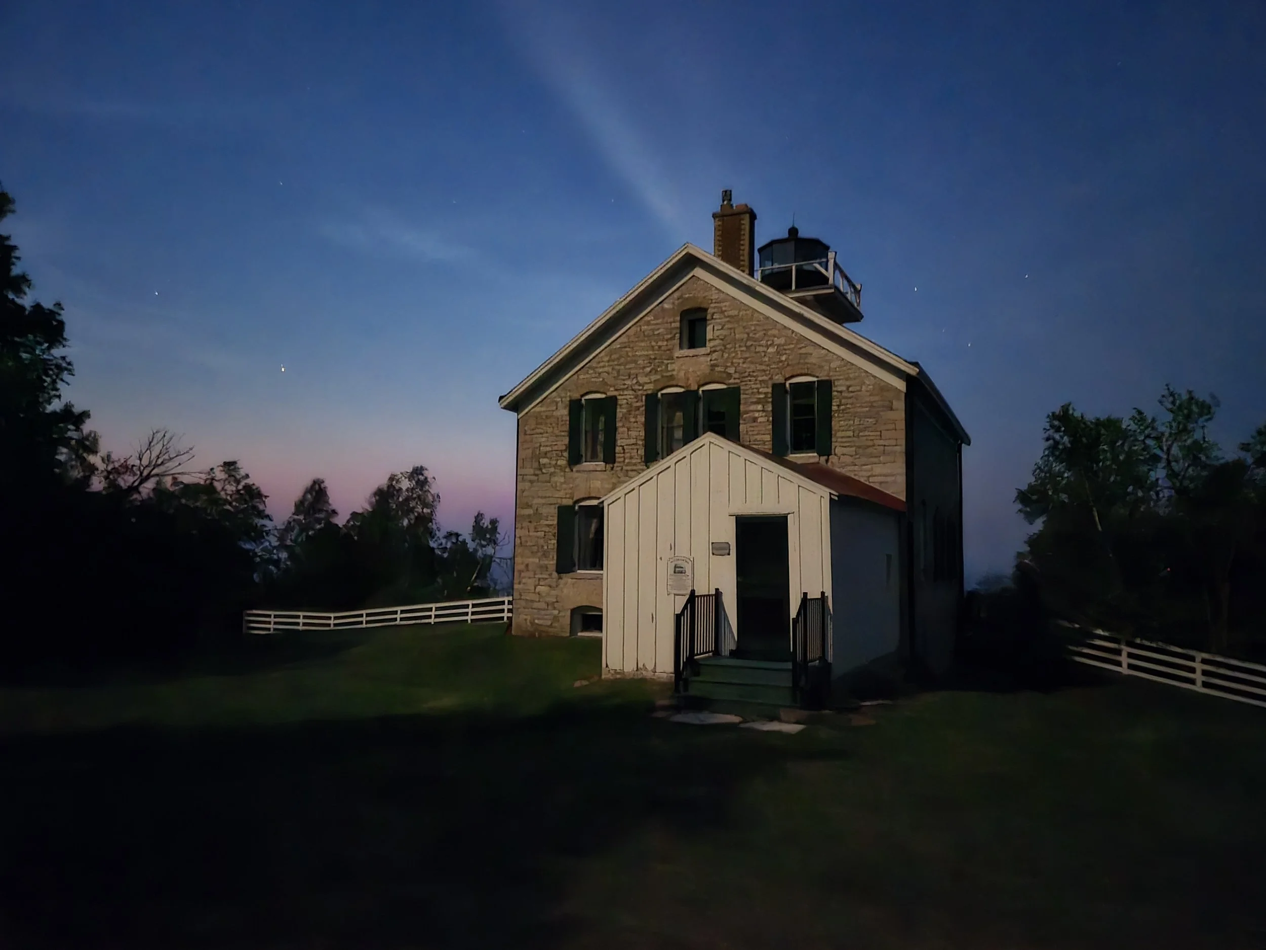 This is a twilight picture of Pottawatomie Lighthouse on Rock Island State Park.