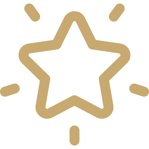 Gold star with small lines radiating outward on a black background.