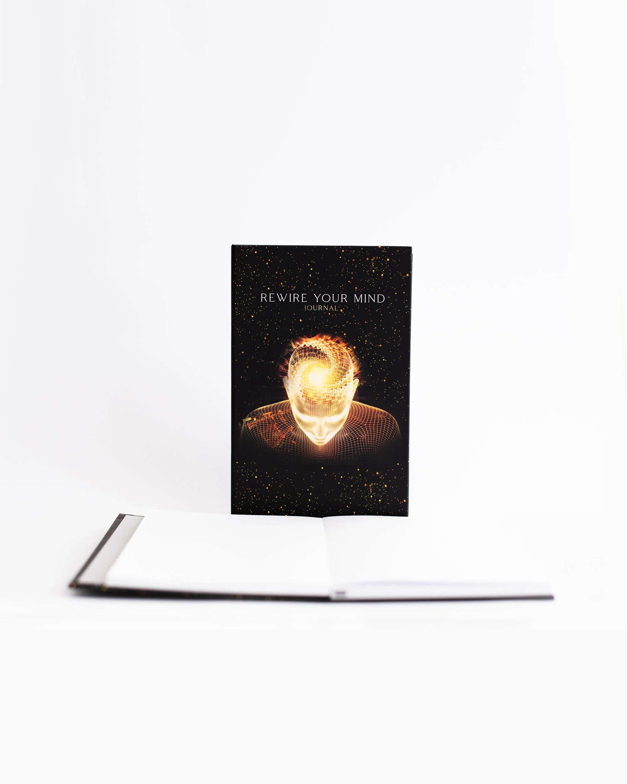 Cover of Rewire Your Mind Journal behind an open journal