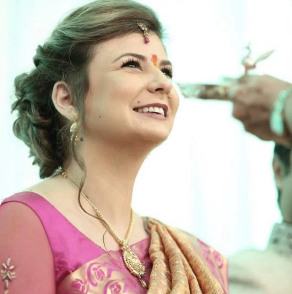 KUMARI founder Amy M. Mali wearing a pink sari and gold jewellery at her engagement ceremony in India.