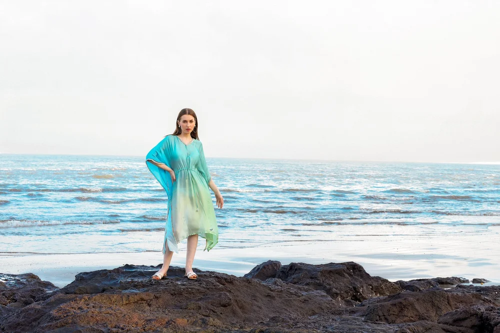 Ocean Jade Kaftan from KUMARI’s Jewels of Paradise collection, photographed on location.