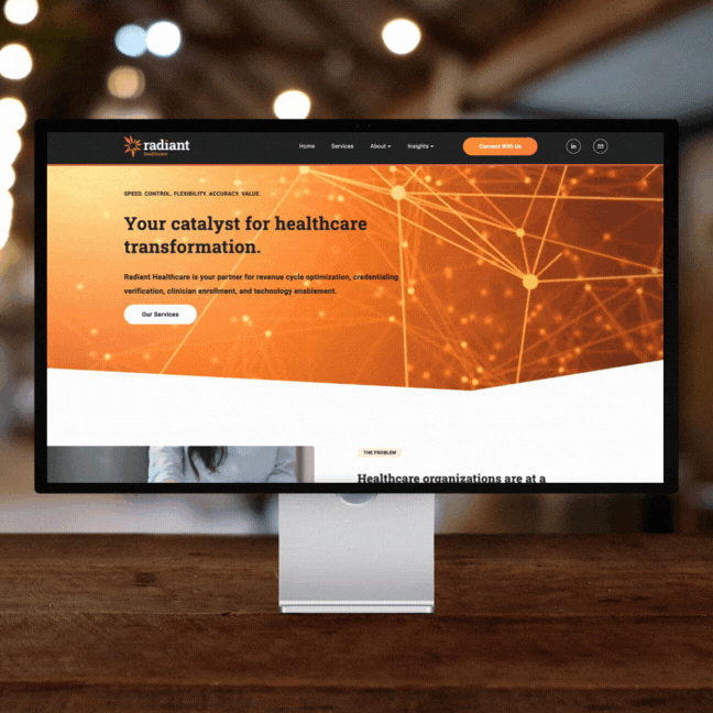 Computer monitor displaying a website for Radiant Healthcare, featuring a header with the text "Your catalyst for healthcare transformation," and options for services, about, insights, and contact information. The design includes connectivity-themed graphics and an orange color scheme.