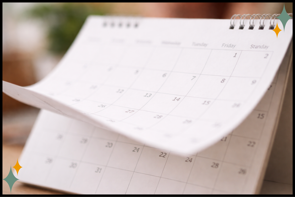 Calendar pages in soft focus, representing reflection on the past year without judgment.