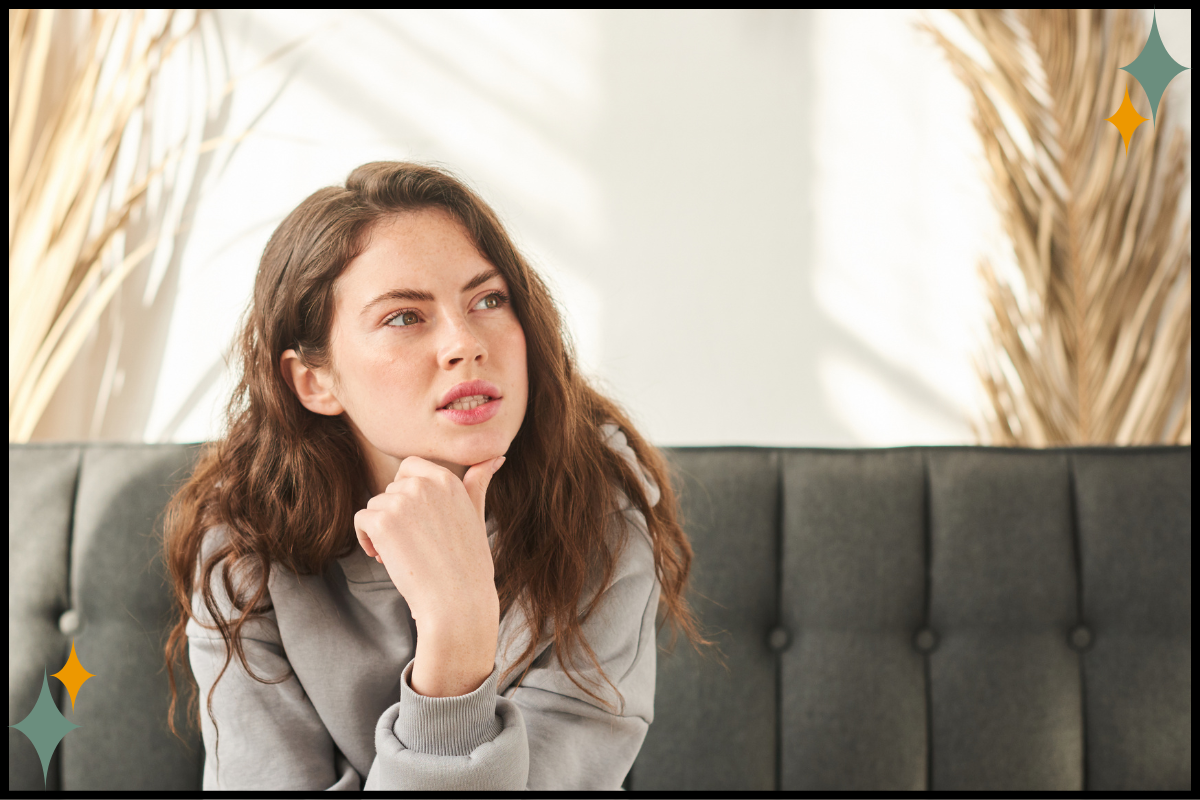 A clinical supervisor pausing thoughtfully during a supervision conversation.