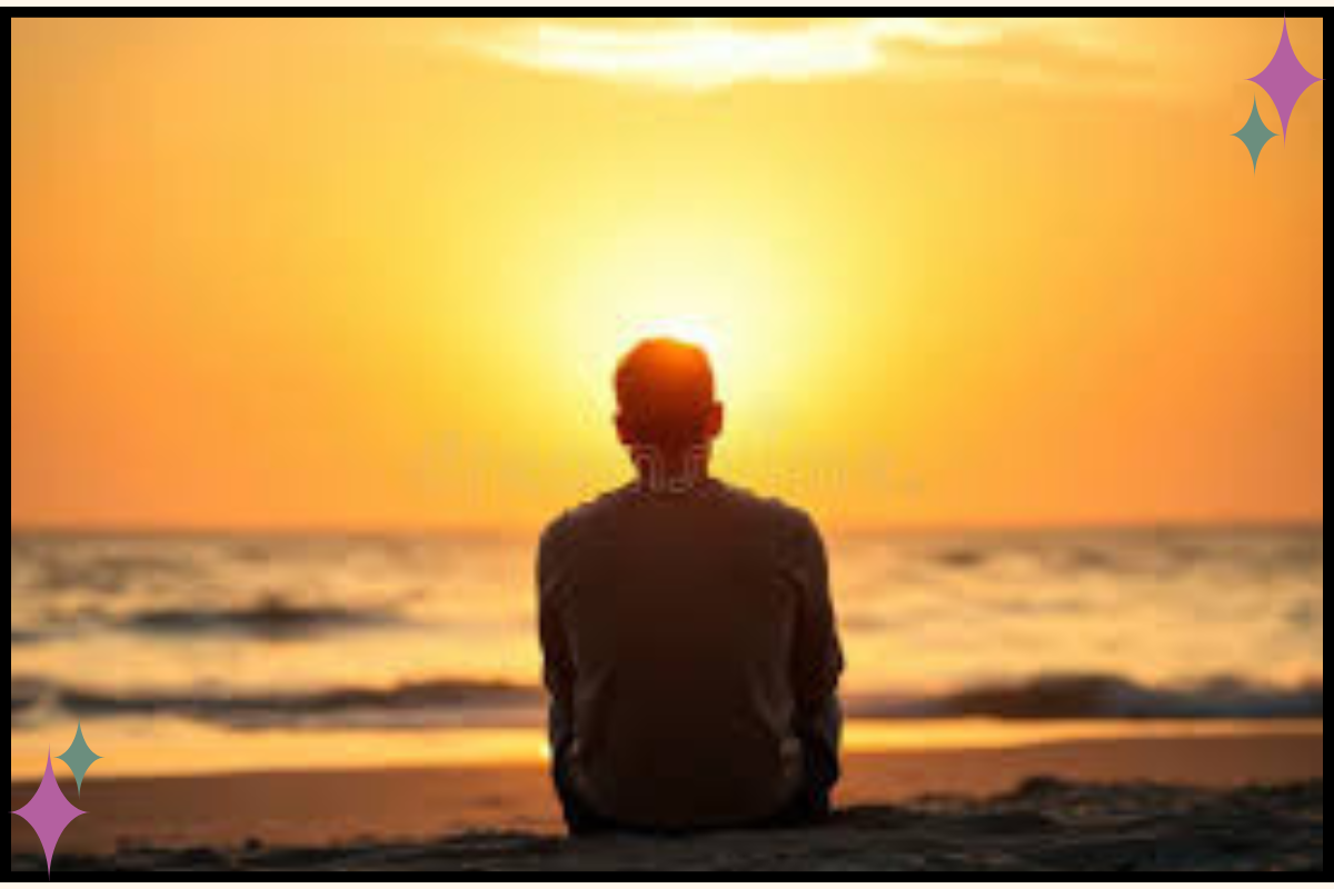 Trauma therapist sitting on beach still looking exhausted, illustrating why vacation doesn't fix vicarious trauma