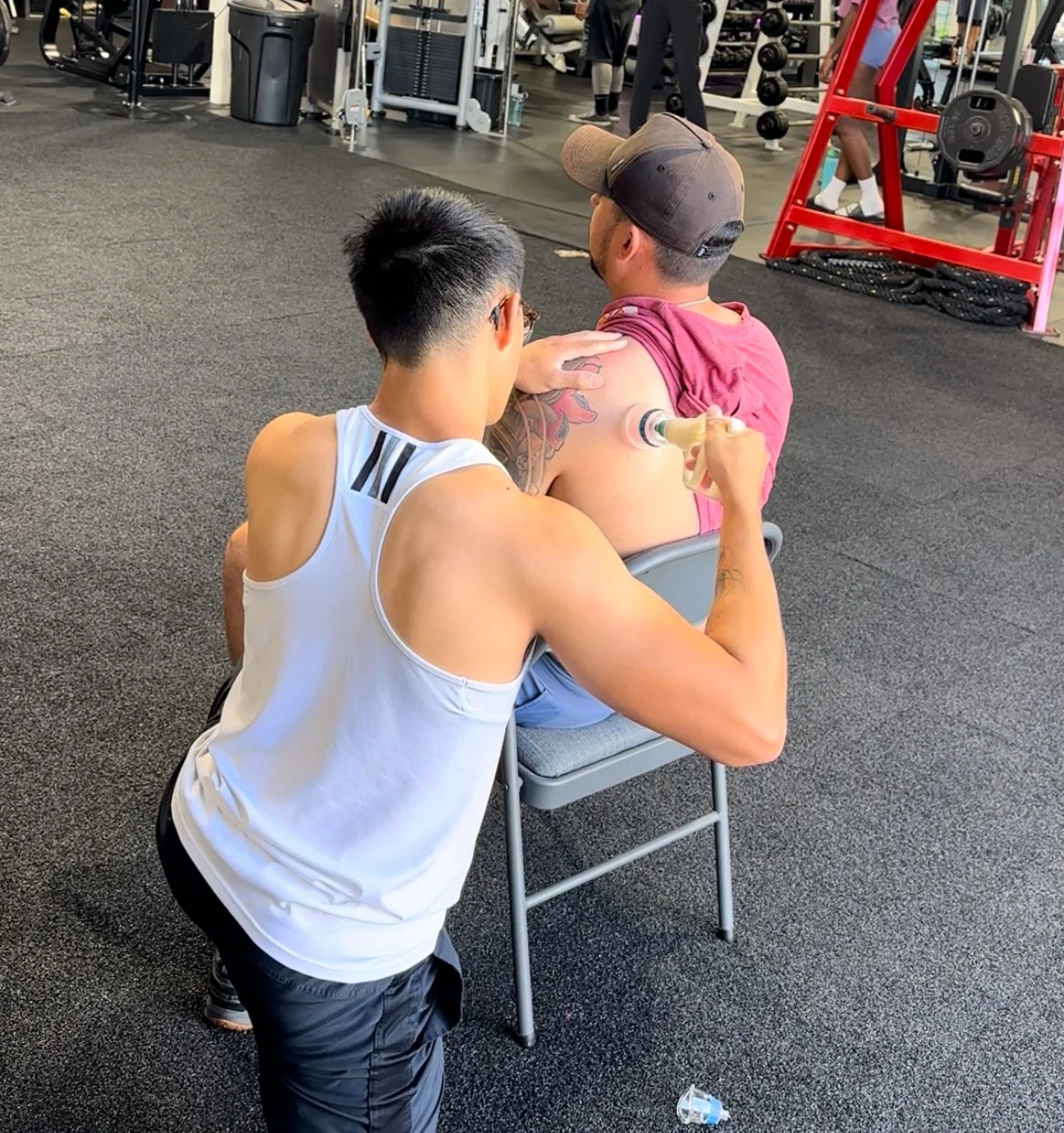 myofascial decompression San Diego, cupping therapy physical therapy San Diego, MFD therapy San Diego, sports cupping therapy San Diego. Physical therapist applying cupping technique to address shoulder pain in athlete in gym in Mira Mesa