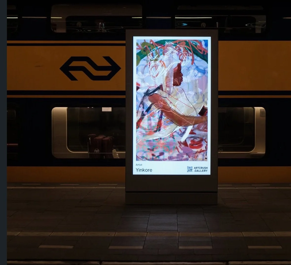 Digital art display at a train station showing a colorful portrait of a woman with a train in the background.