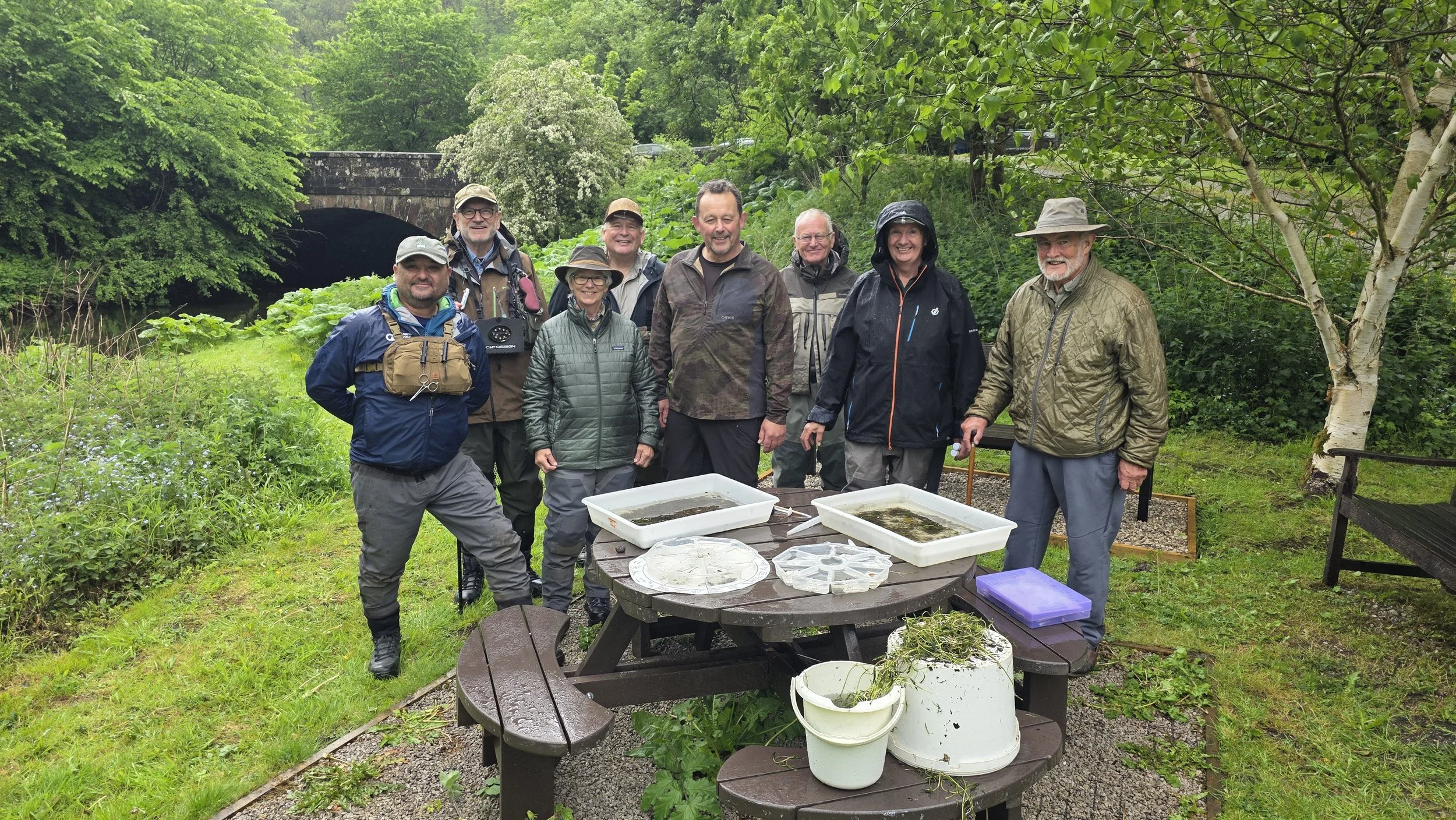 Riverfly monitoring group on river bank