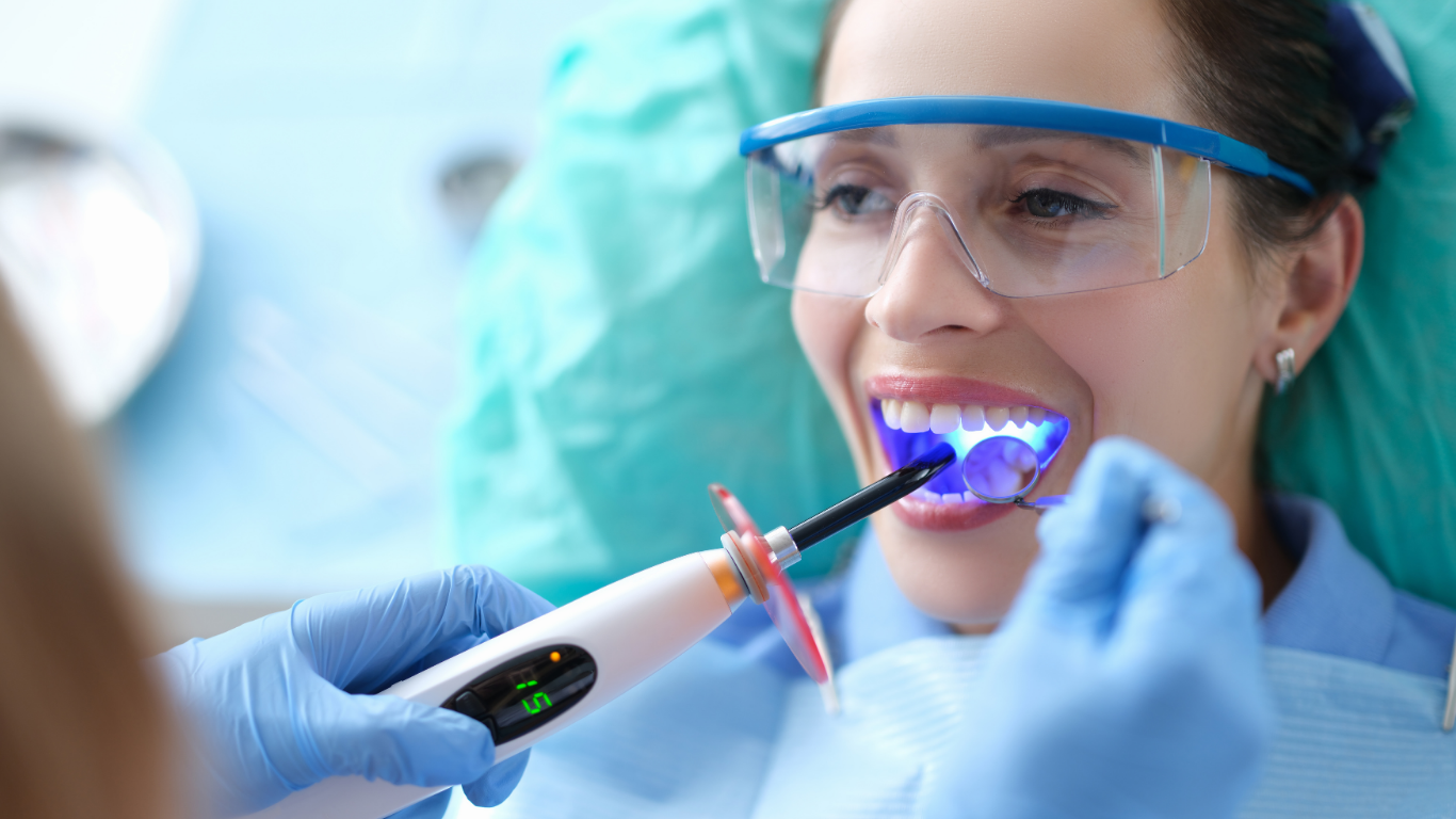 Patient Having Treatment Image Patient undergoing cosmetic dental treatment in a modern dental clinic, demonstrating minimally invasive aesthetic dentistry and smile enhancement procedures.