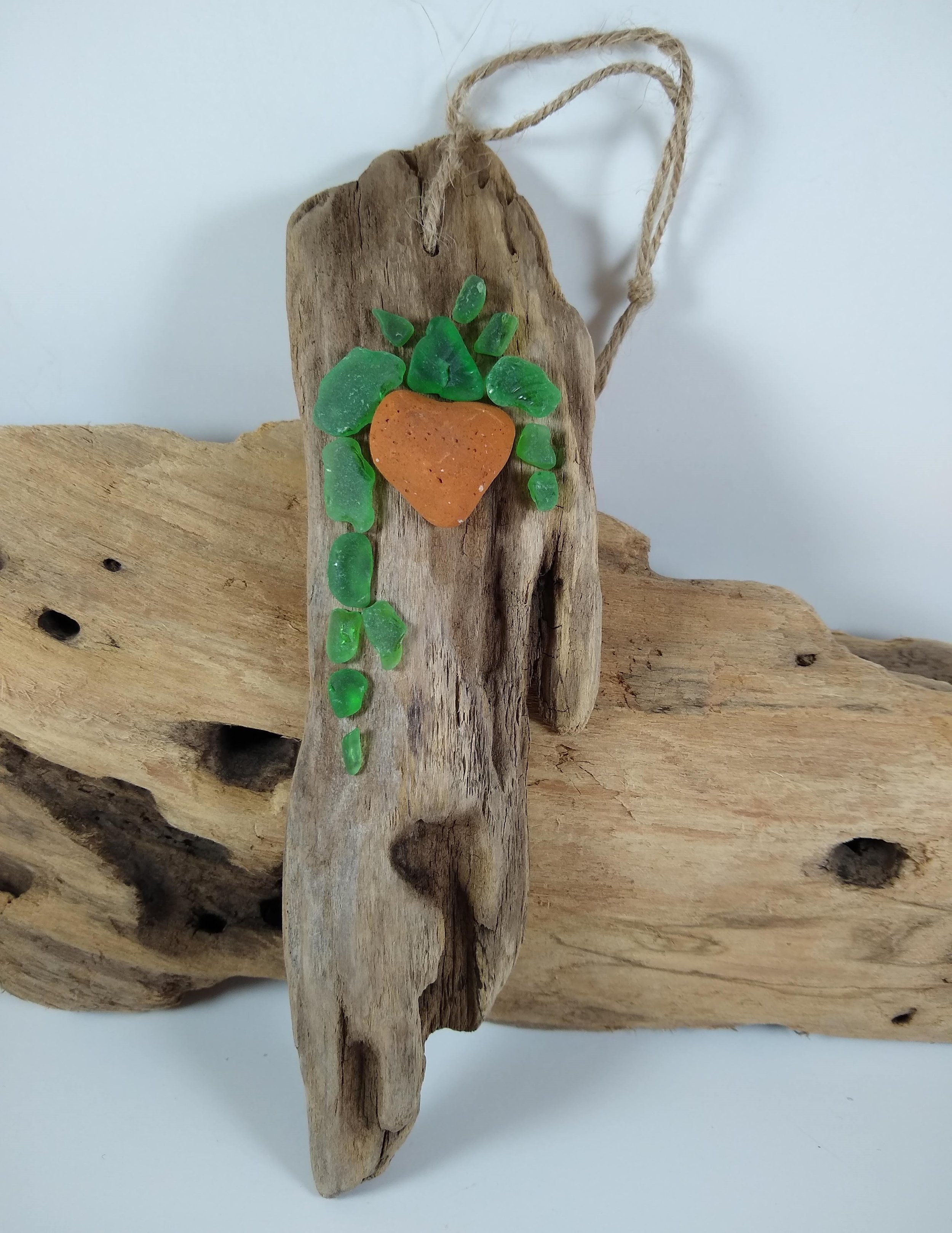 This gnarly wood was just meant to have this pretty hanging plant created with beach glass and pottery.