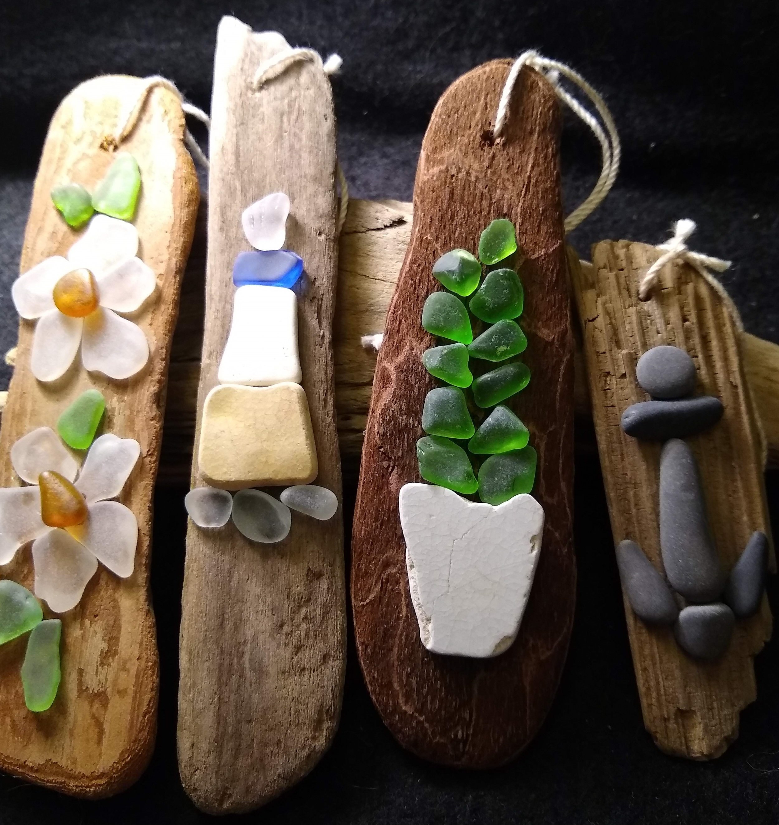 Fun driftwood ornaments created with beach glass, pottery and stones.