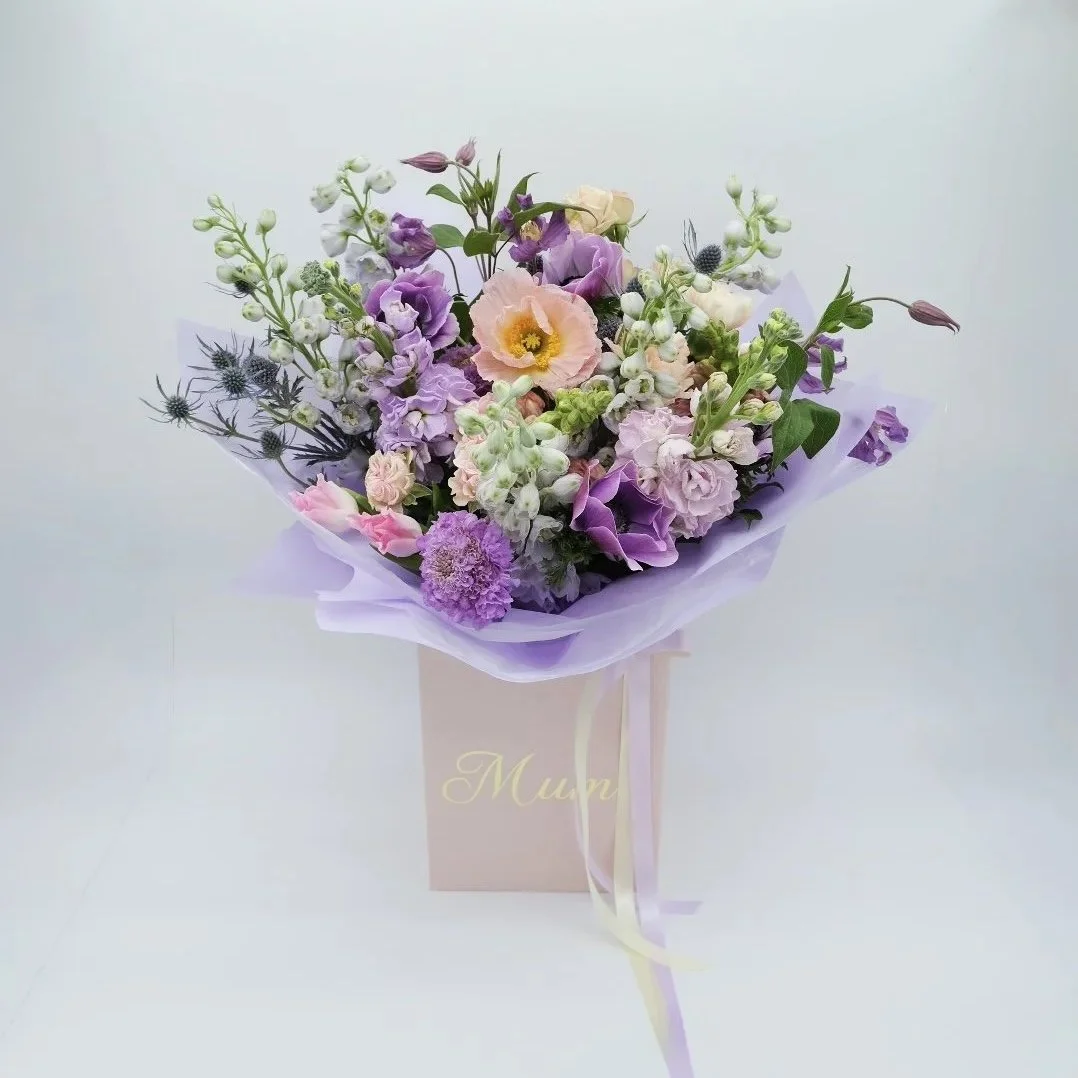 mums-lavender-haze-bouquet-with-poppies-stocks-anemones-thistles-and-other-spring-blooms-wrapped-in-lilac-and-boxed-in-bloom-studio.jpg