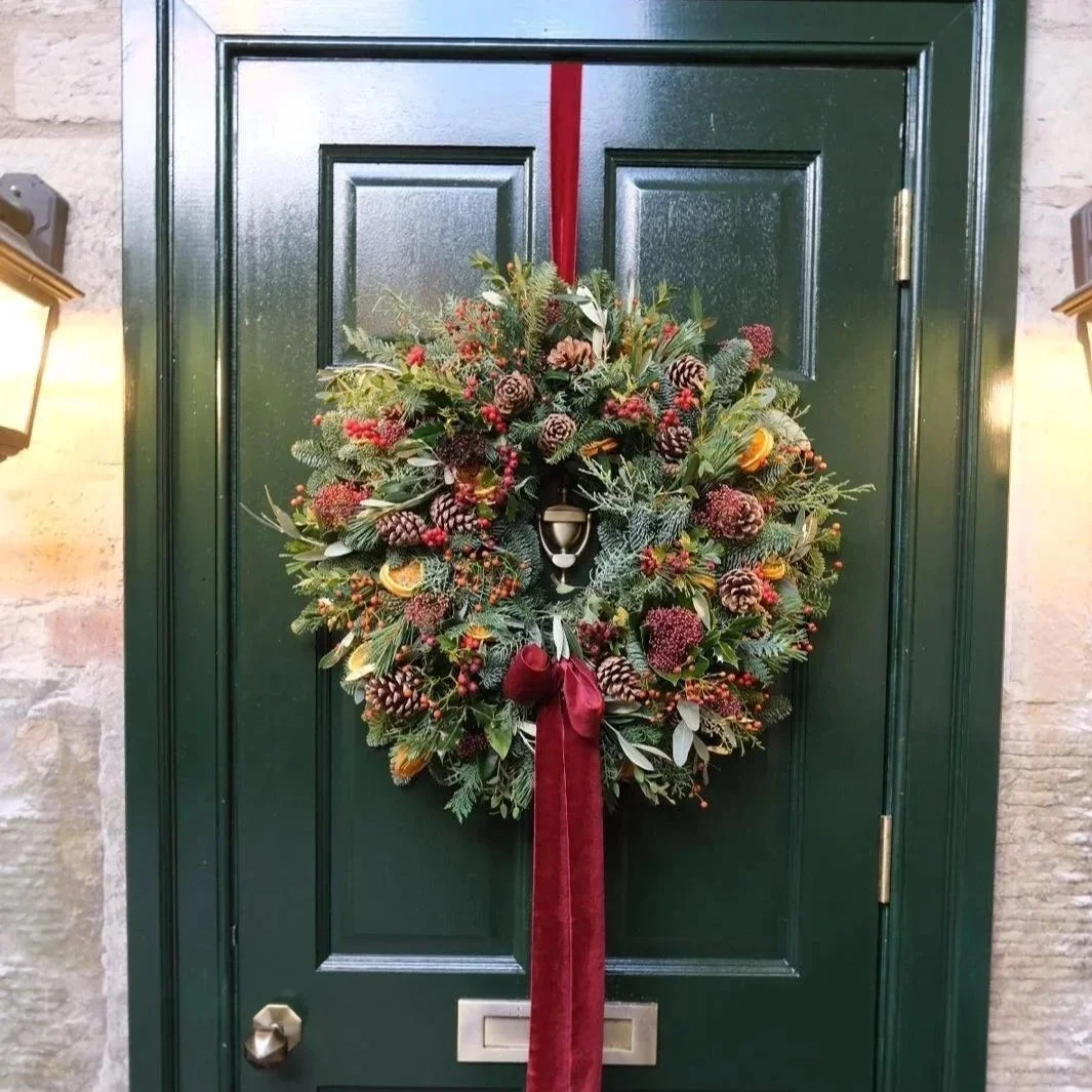luxe-christmas-wreath-in-bloom-studio-dressed-with-pine-cones-oranges-berries-and-finished-with-a-red-bow-availble-for-delivery-in-edinburgh-and-the-lothians.jpg