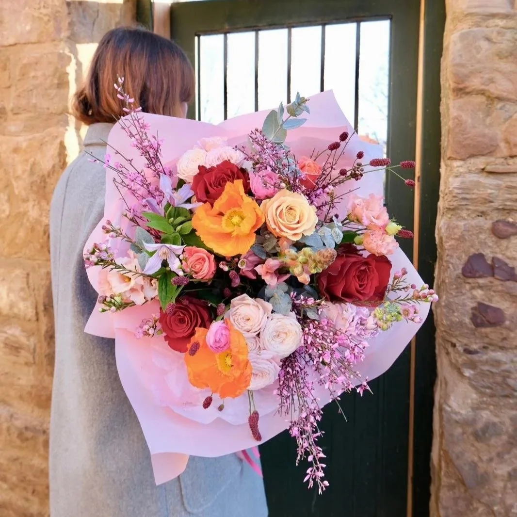 Spring-Valentines-Bouquet-With-Poppies-And-Roses-Wrapped-In-Pink-With-Satin-Ribbons.jpg