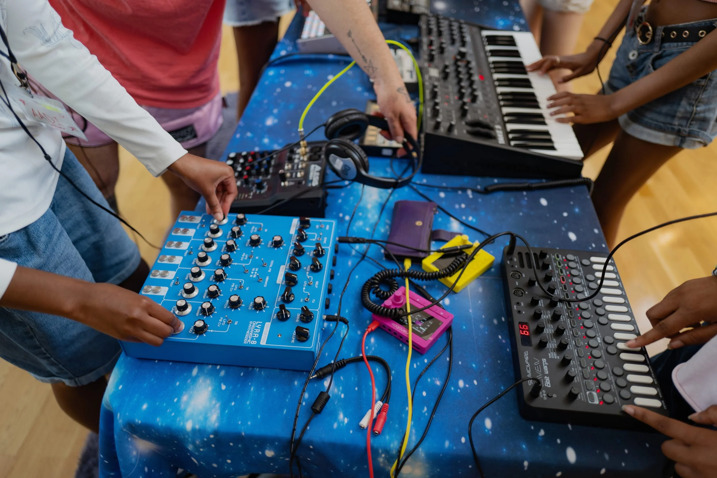 Close up of students using music mixing equipment