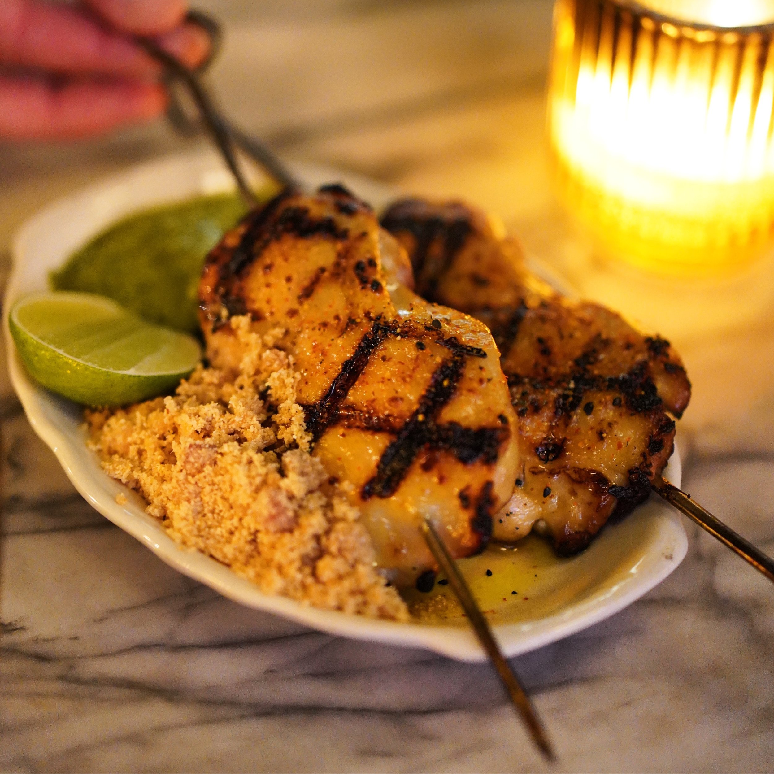Crispy Chicken Thigh Xixo 😋 They&rsquo;re served with Togarashi + Chimichurri + Farofa and are one of our many xixo/skewer options at Nossa Caipirinha Bar 😎🇧🇷🍽️ Come see for yourself! Open tonight 4pm-12am🤍