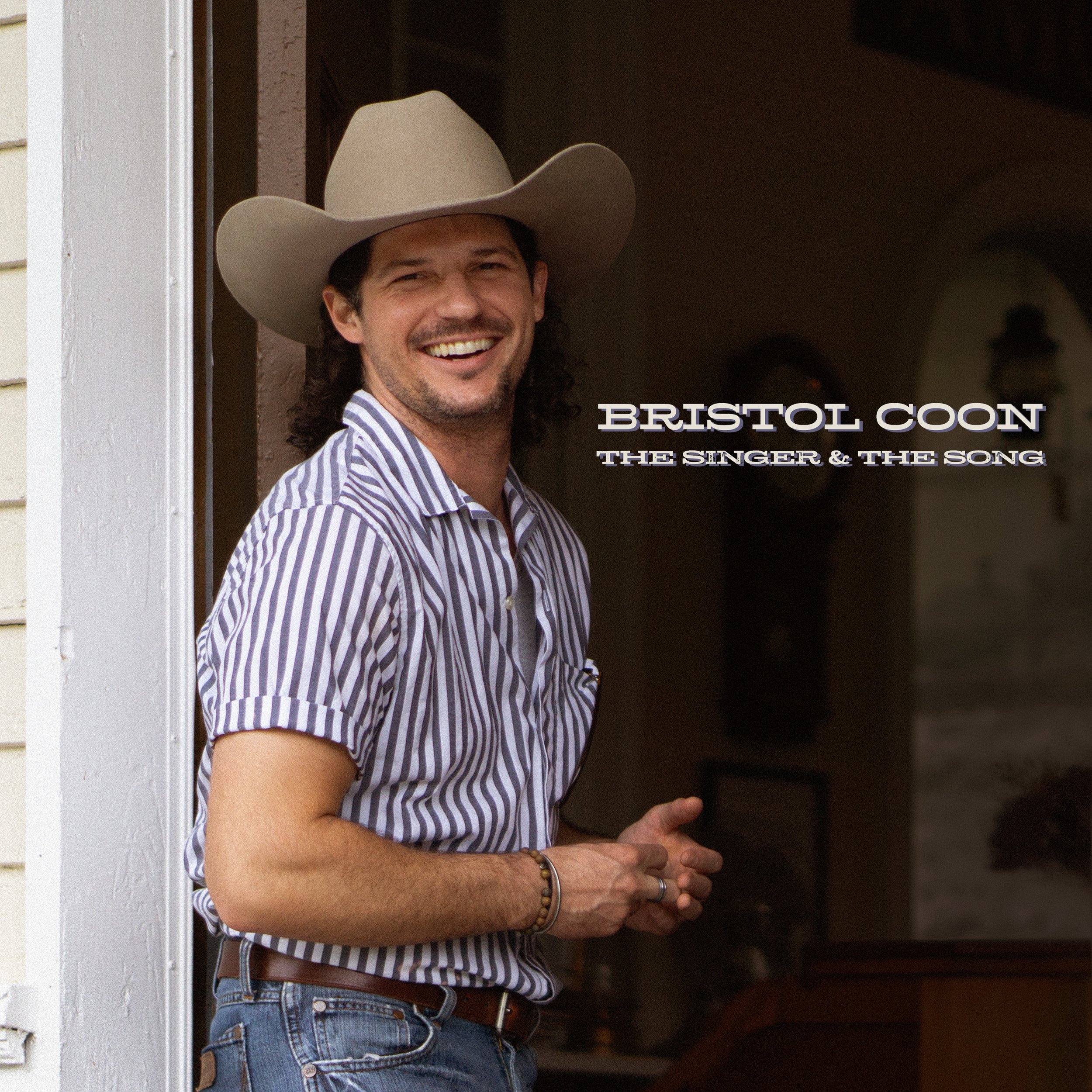 Country singer in cowboy hat smiling used as an album cover for a country album.