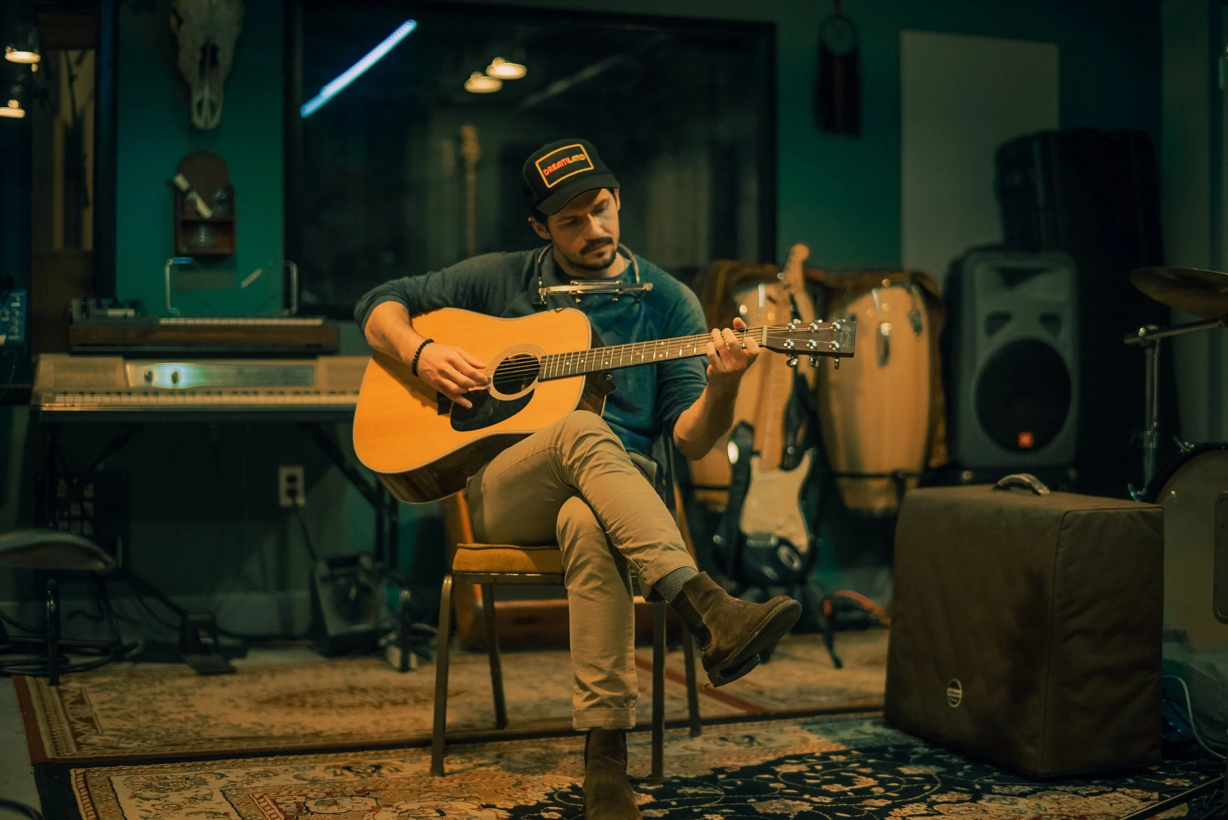 Man playing guitar in music studio in full color. Country singer playing guitar in music studio.