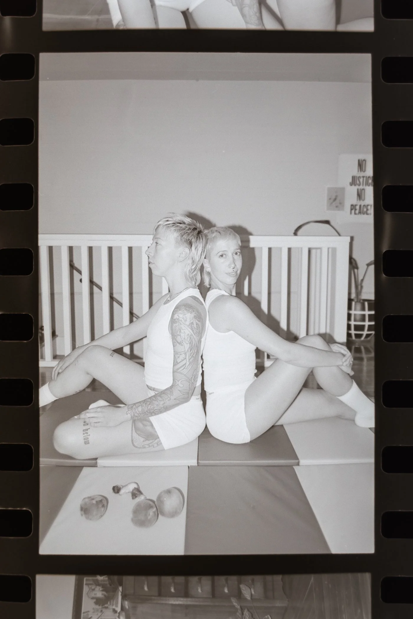 black and whit image on film two people dressed the same.