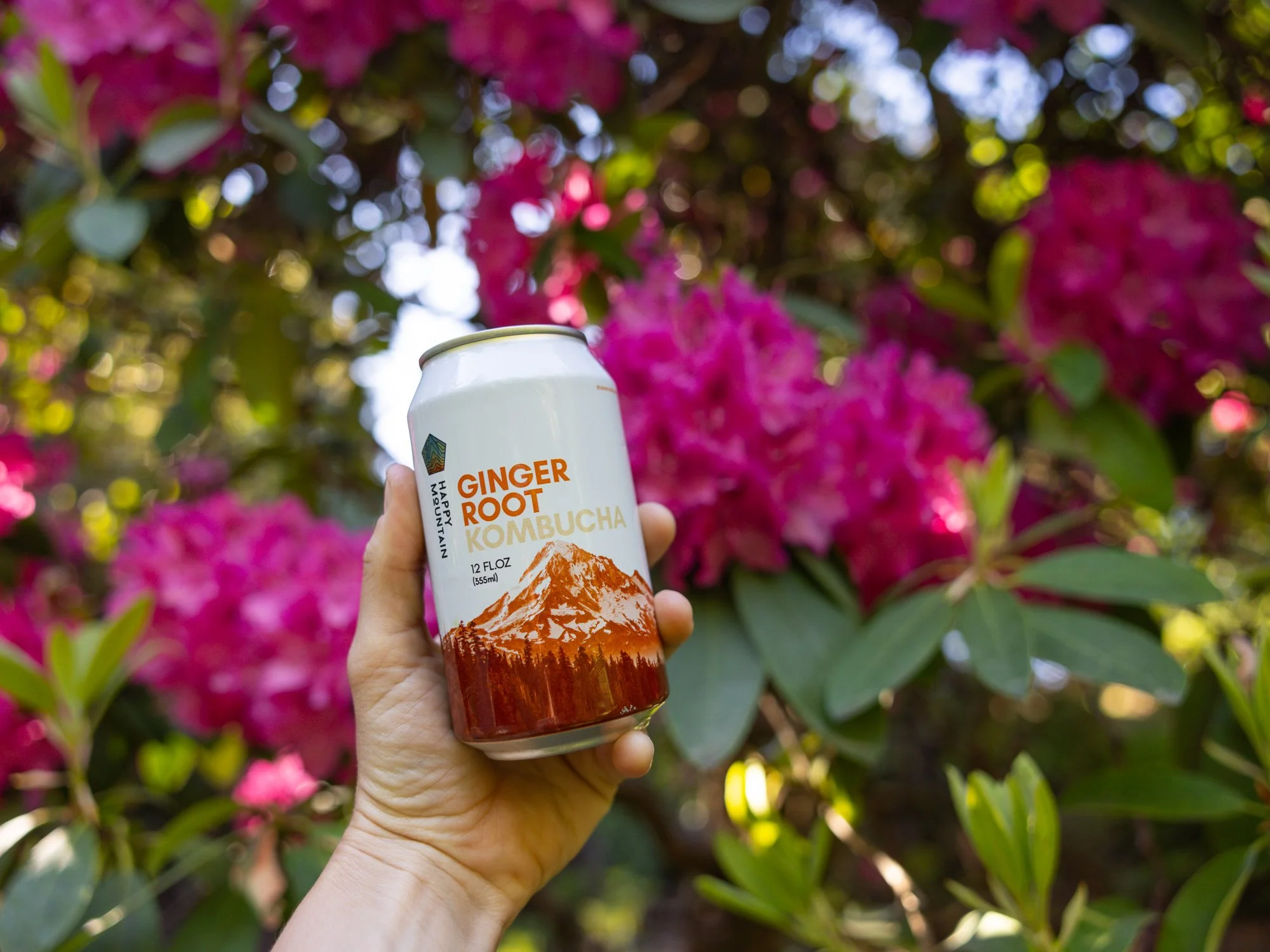 happy mountain kombucha can with flowers.