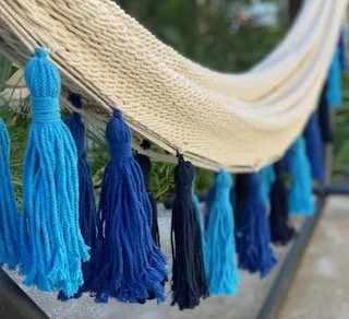 "PEACOCK" with blue tassels