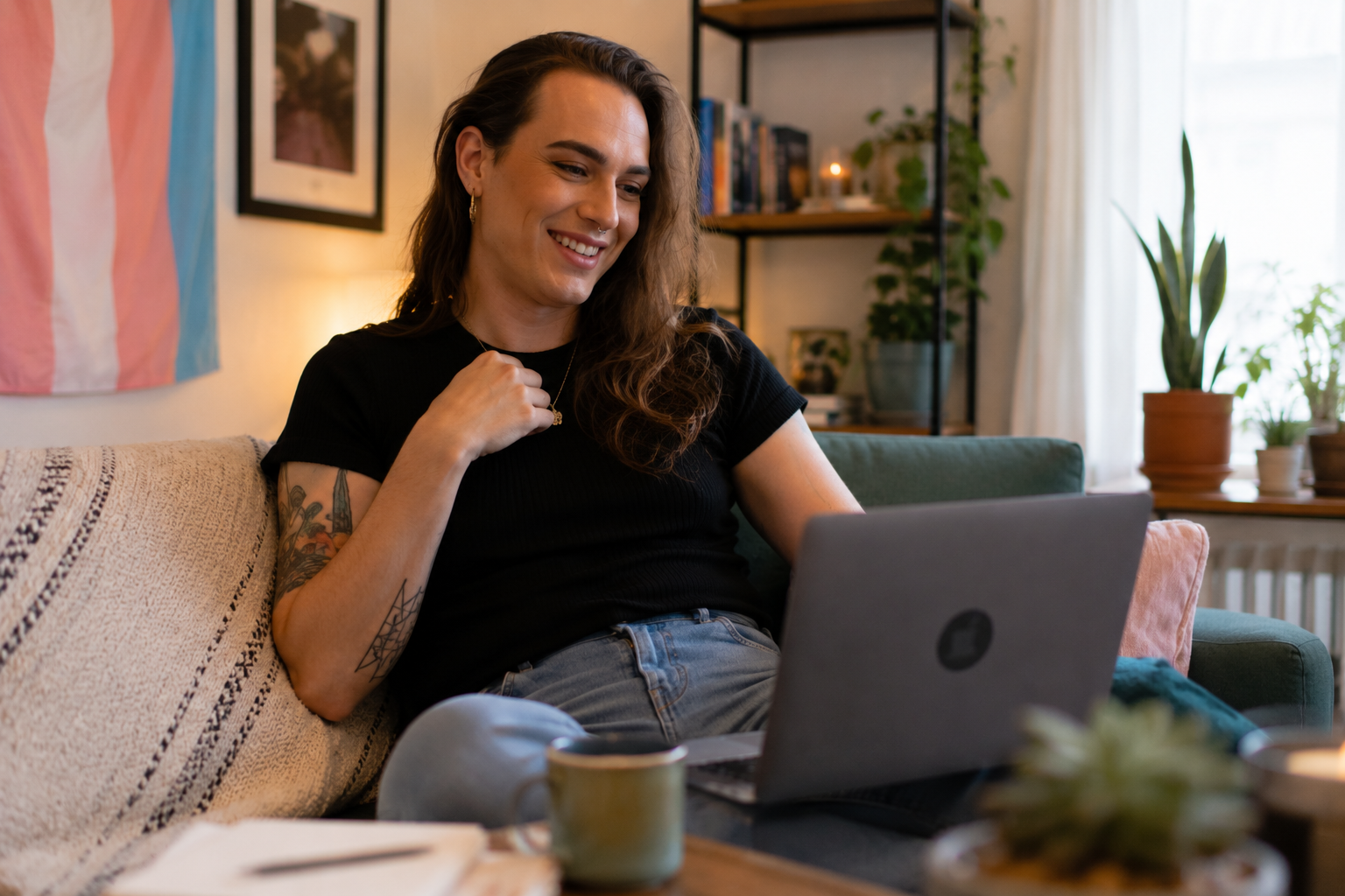 Transgender adult smiling during an online therapy session from their home in Illinois.