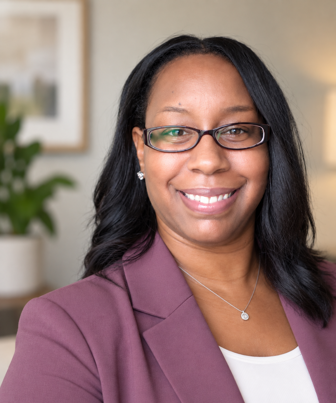Dr. Aretha Steele, licensed clinical psychologist and founder of Mindful Healing Counseling, smiling warmly in a professional therapy office.