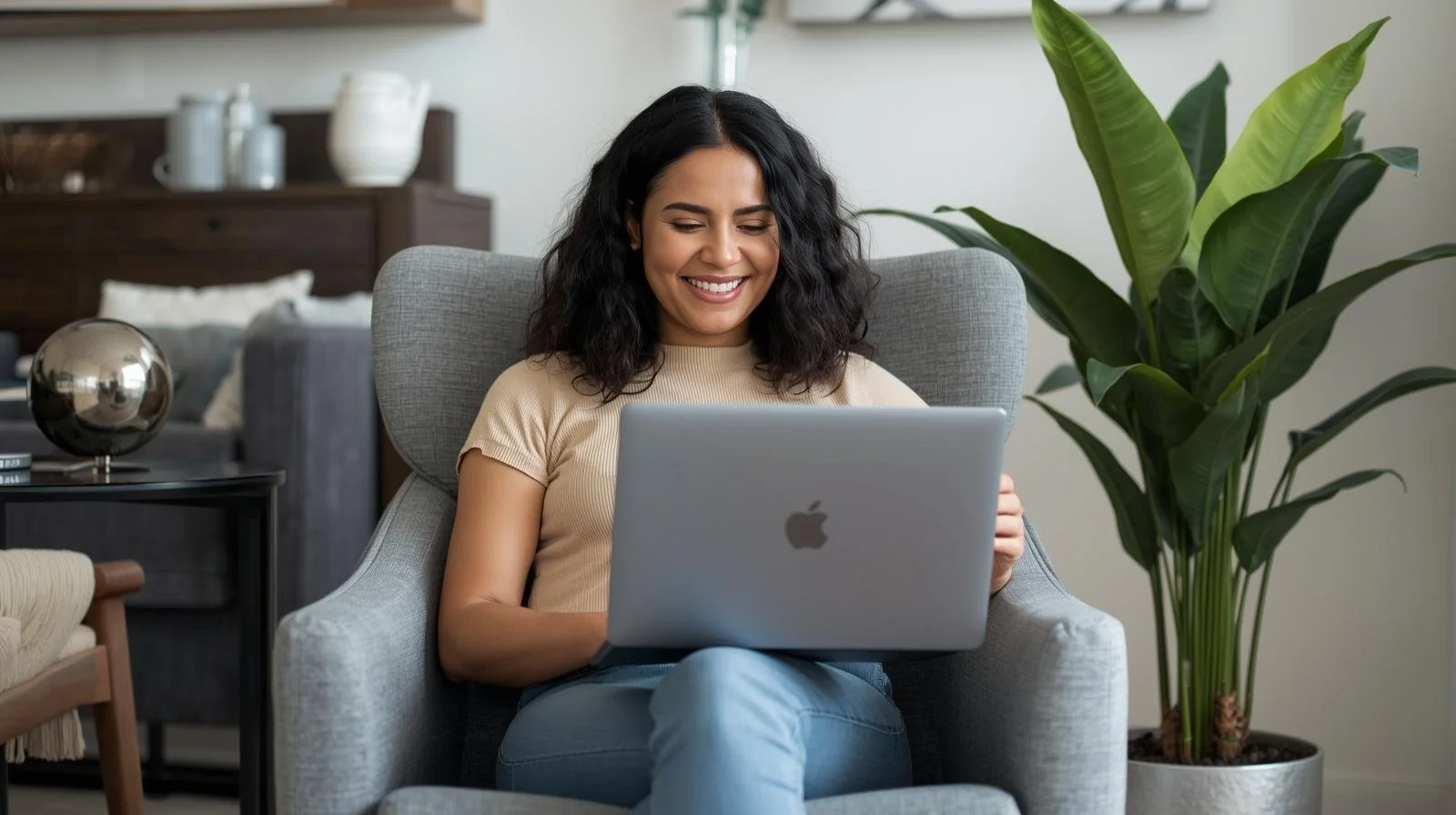 Hispanic woman in her 30s sitting comfortably with a laptop in a modern living room, representing supportive online therapy for adult children of immigrants in Chicago and Illinois