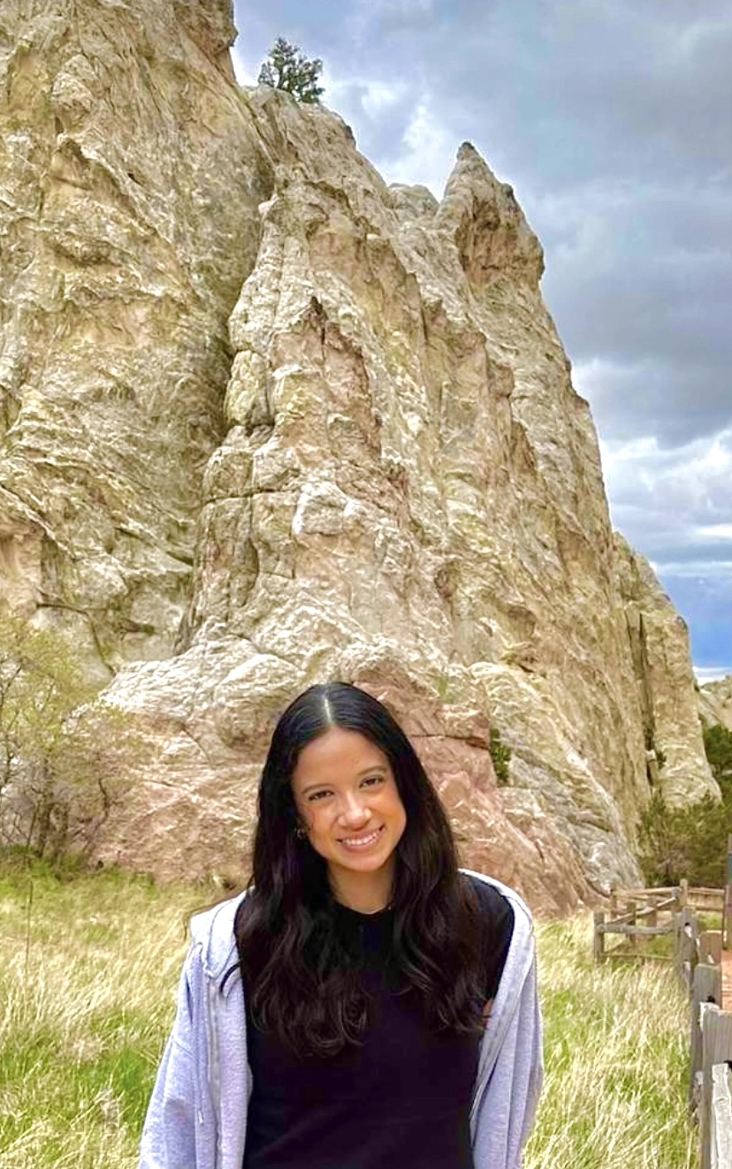 Fabiola Felix standing outdoors with mountains in the background, reflecting balance and connection with nature outside of therapy