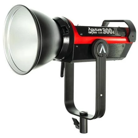 A black and red studio strobe light with a large reflective focusing pointed reflector and a stand for photography or videography.