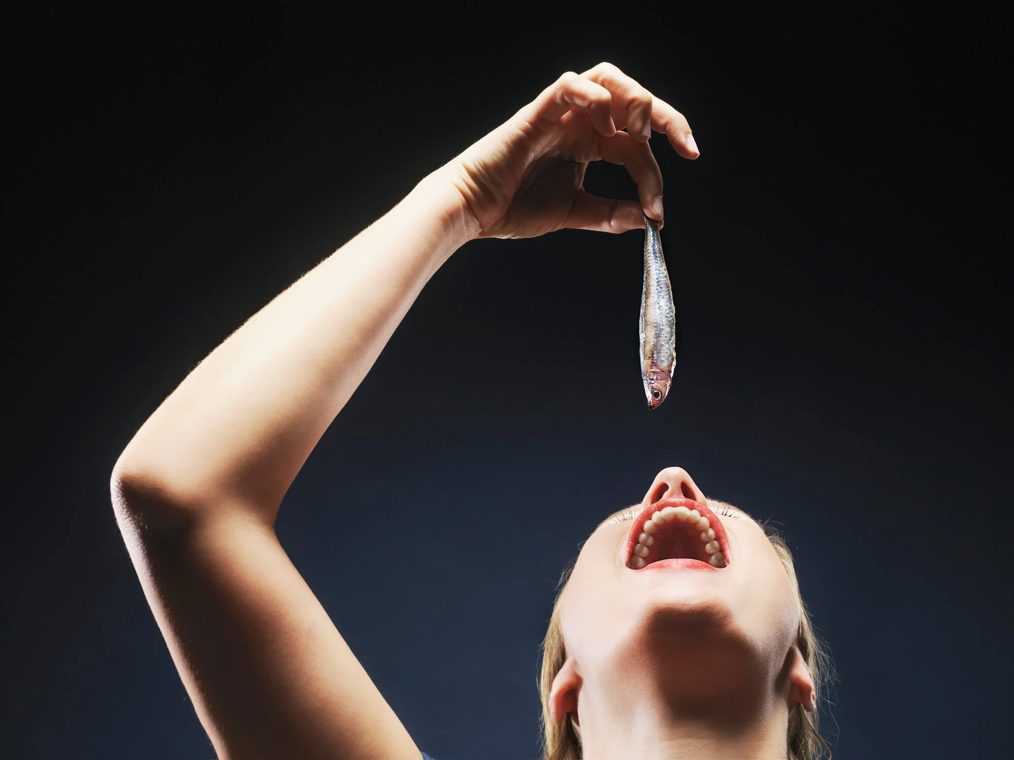 girl swallowing fish