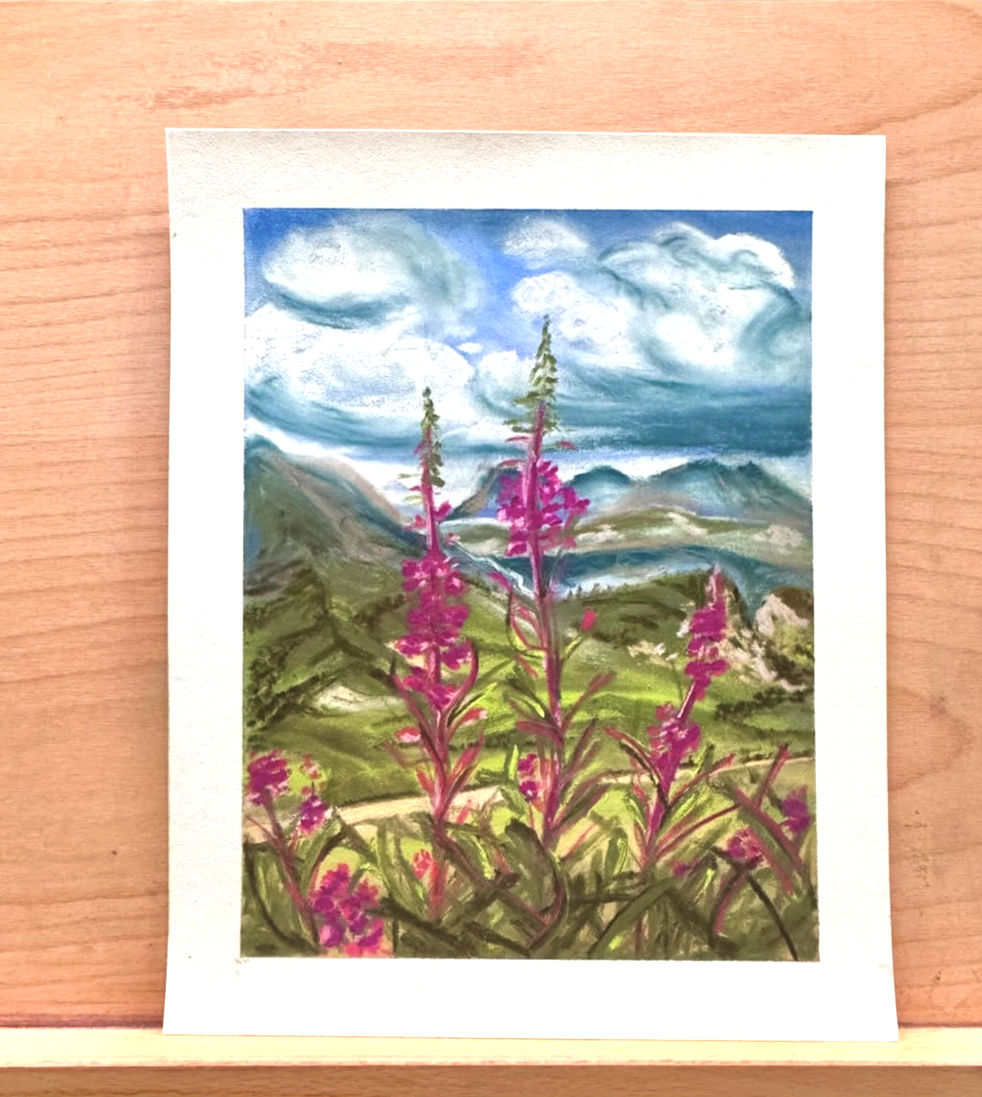 A landscape painting of mountains, sky with clouds, and pink flowers in the foreground.
