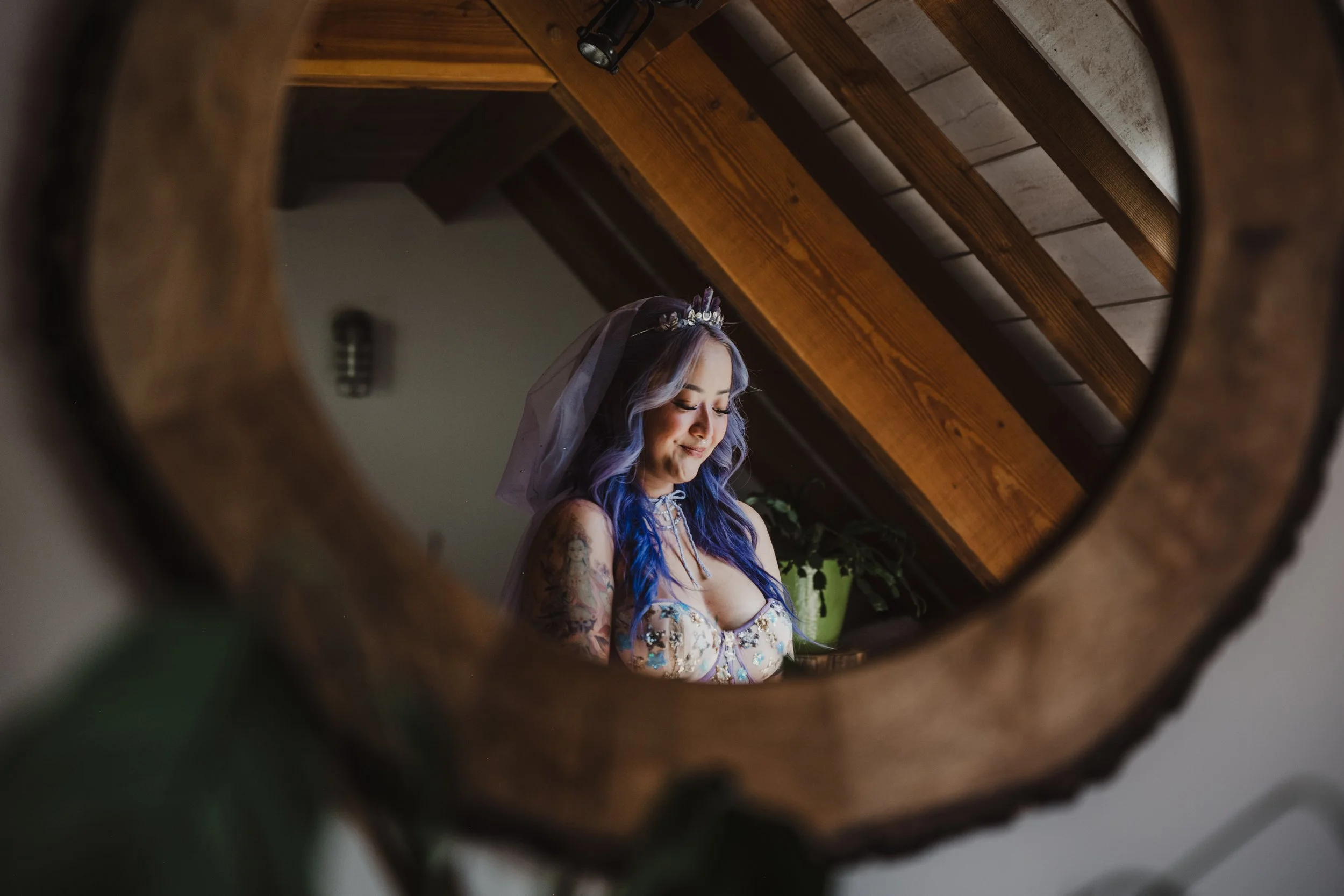 bride wearing purple, with tattoos, in mirror, vancouver island wedding