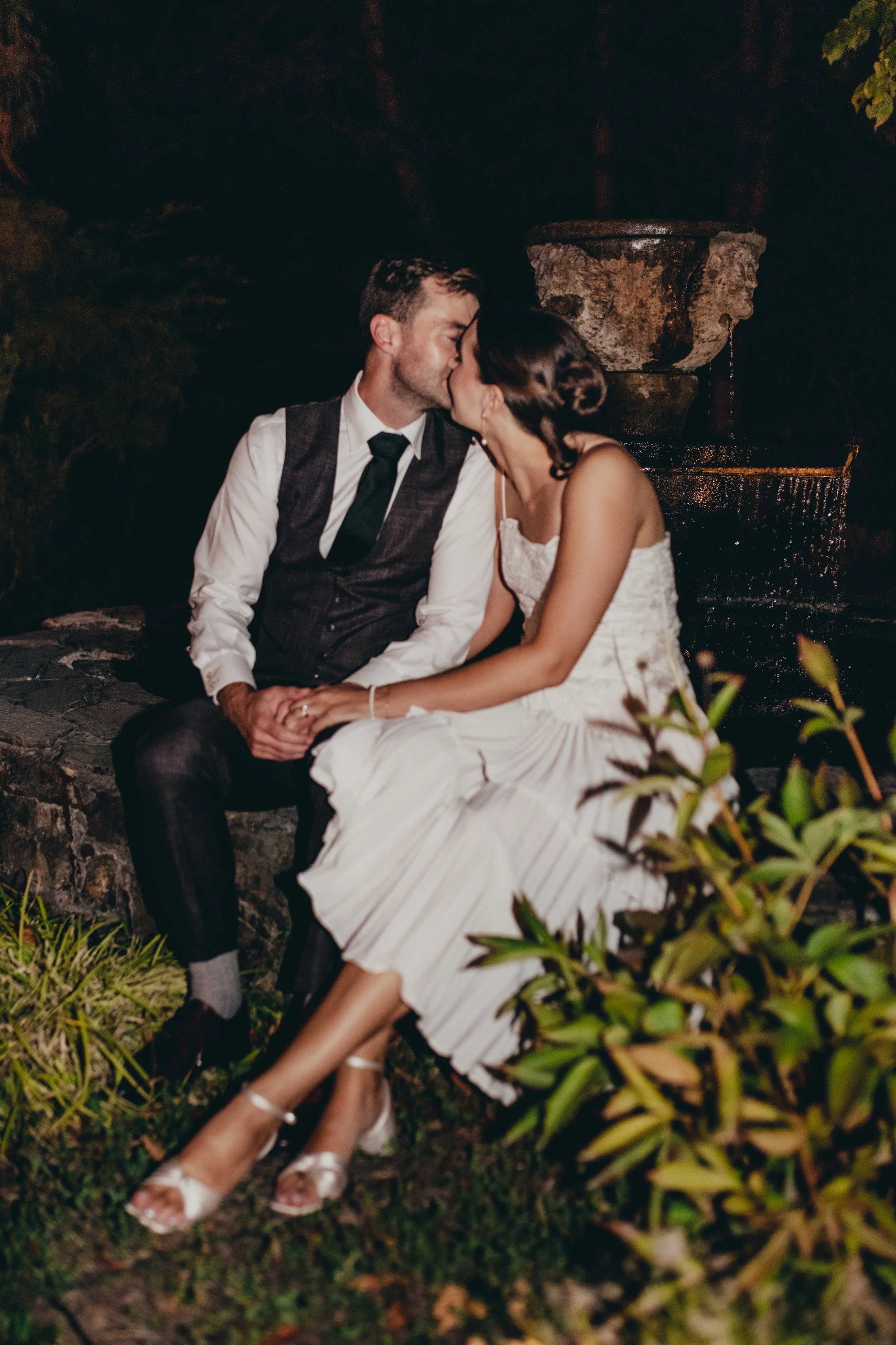 Couple kissing at the fountain at Galiano Inn